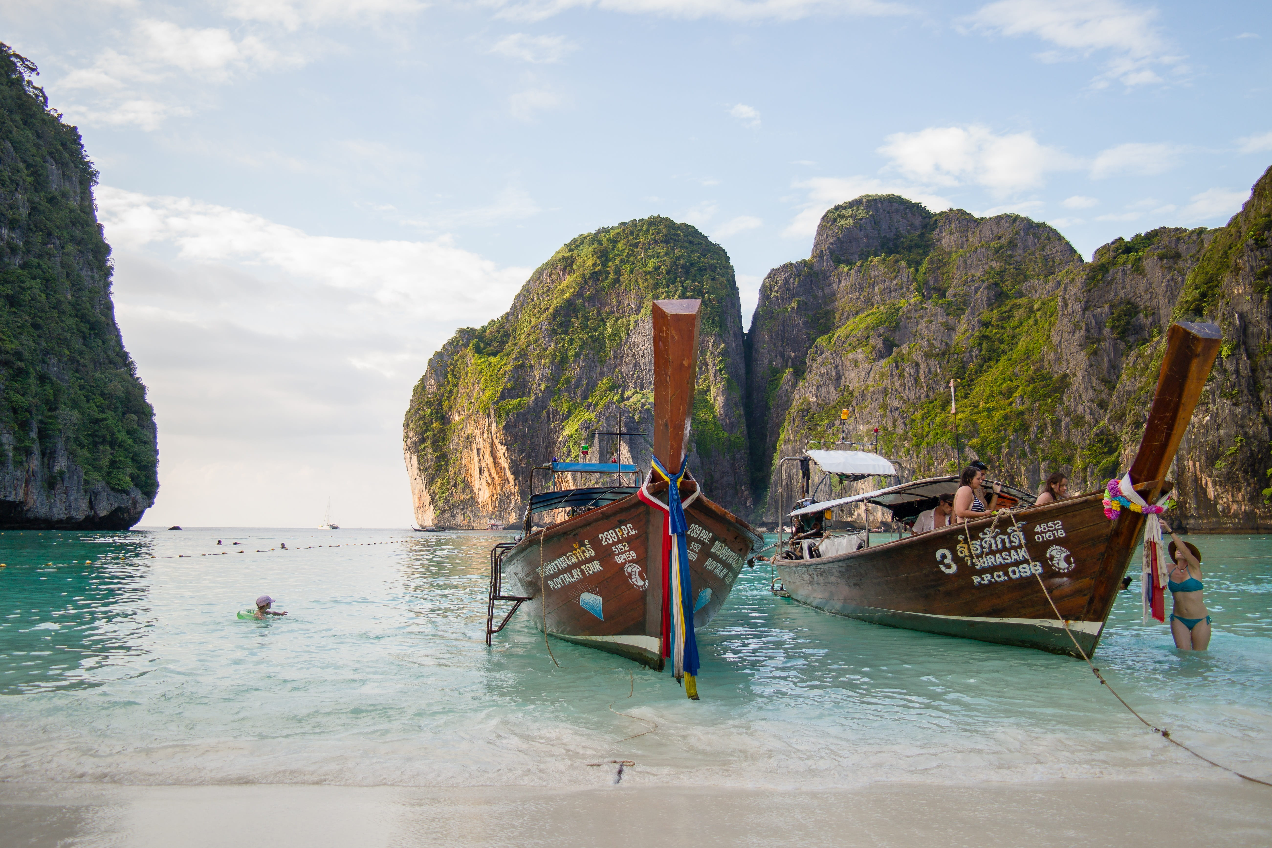 two brown boat near beach rock formation, thailand, the beach