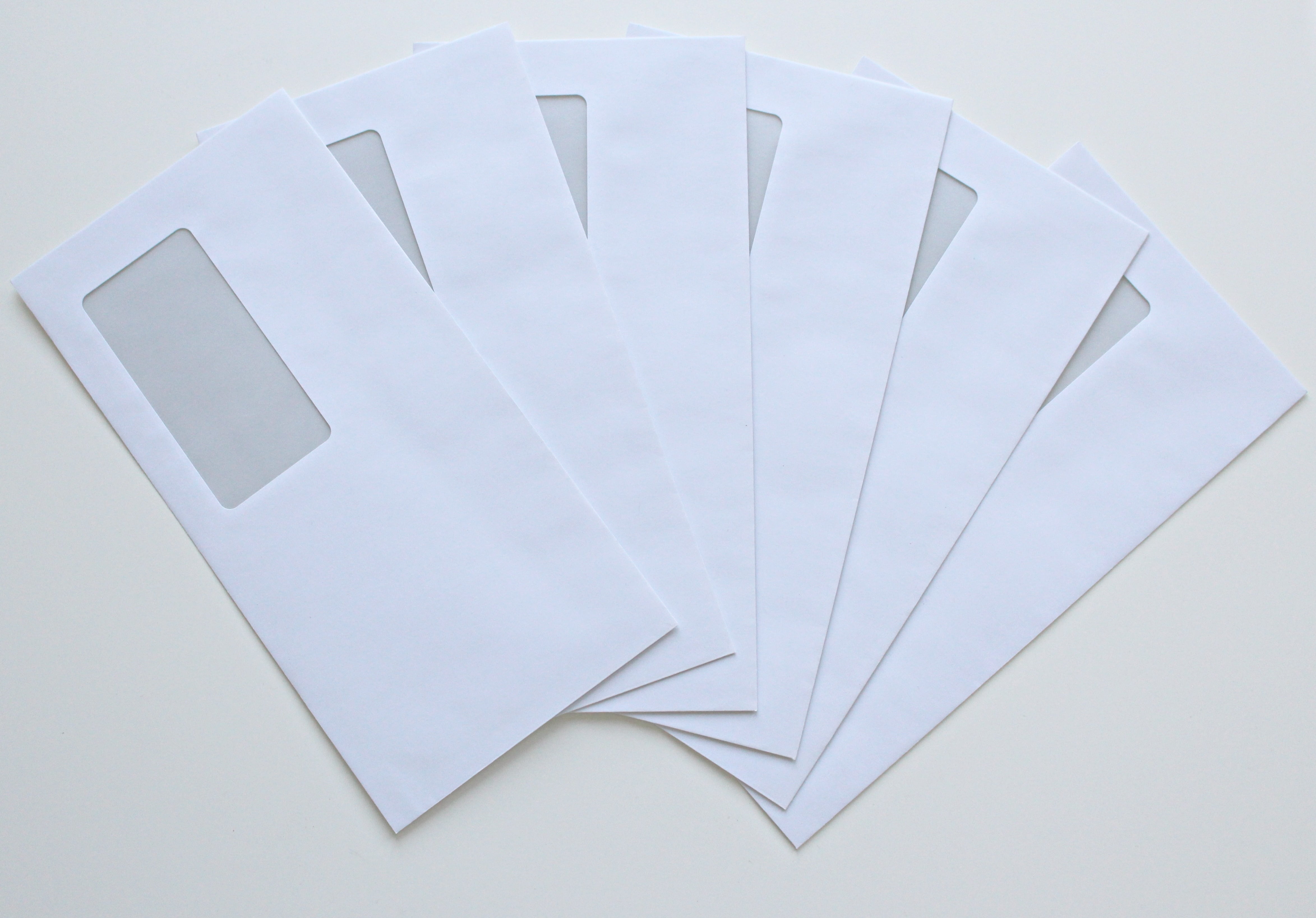 six white windowed envelopes, post, paper, letters, leave, message