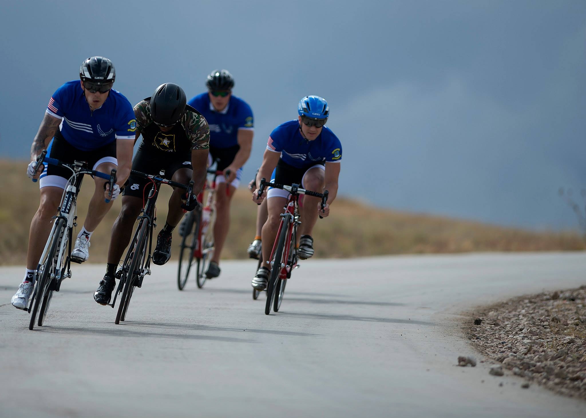 four man riding bicycles on asphalt road, cycling, cyclists, riders