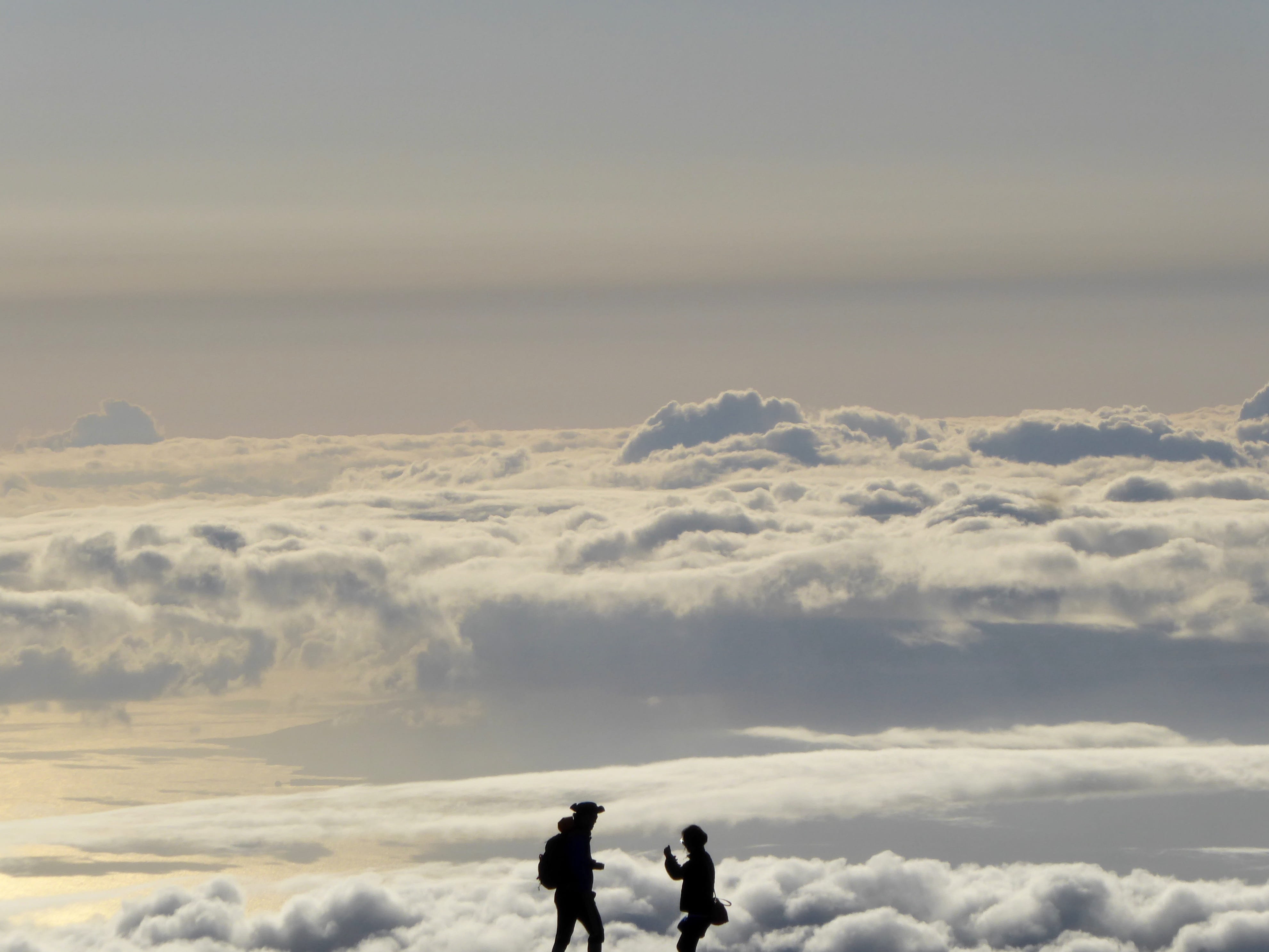 walking on the clouds, two men silhouette with clouds background