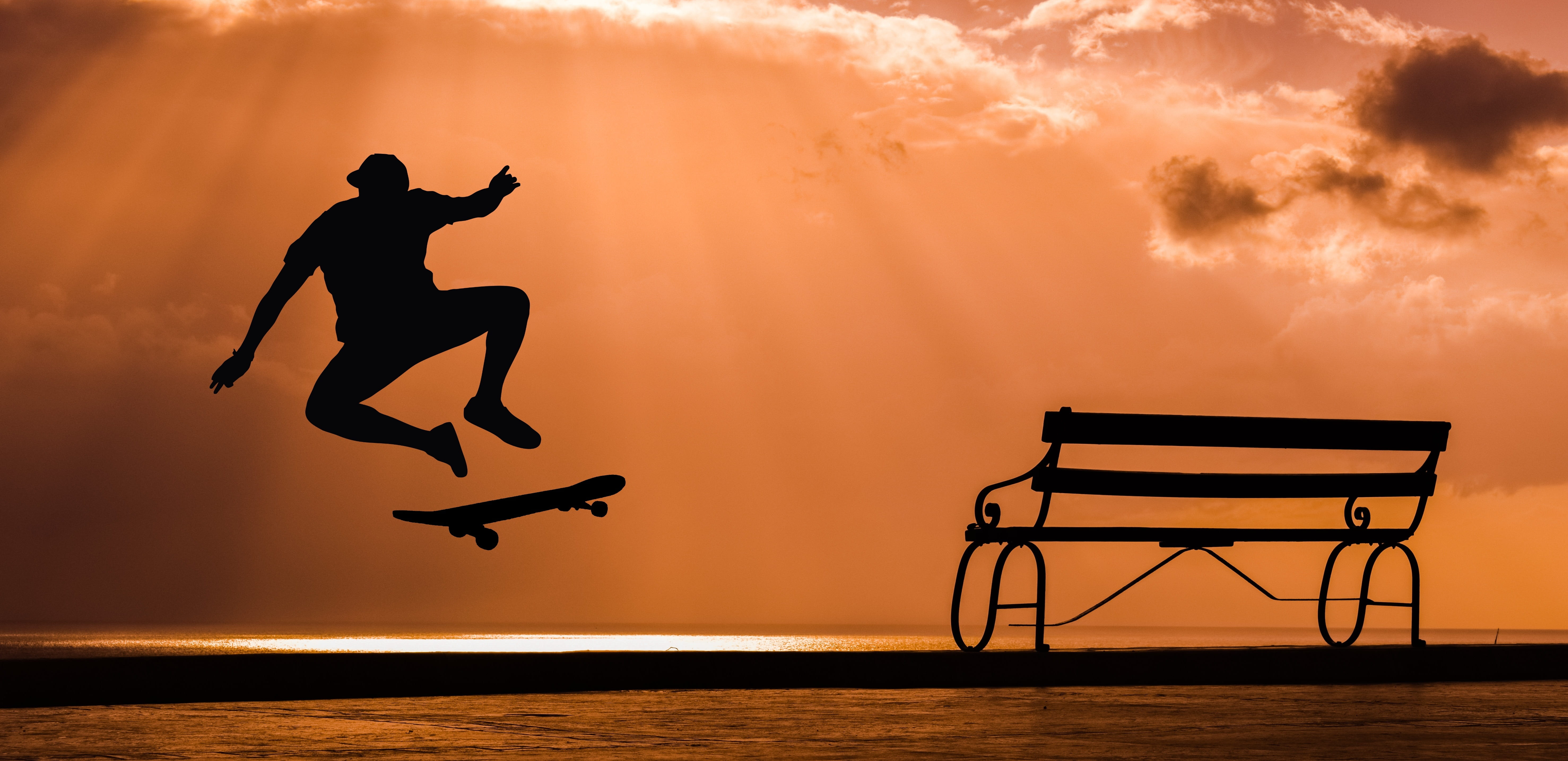 silhouette of person playing skateboard during golden hour, skateboarder