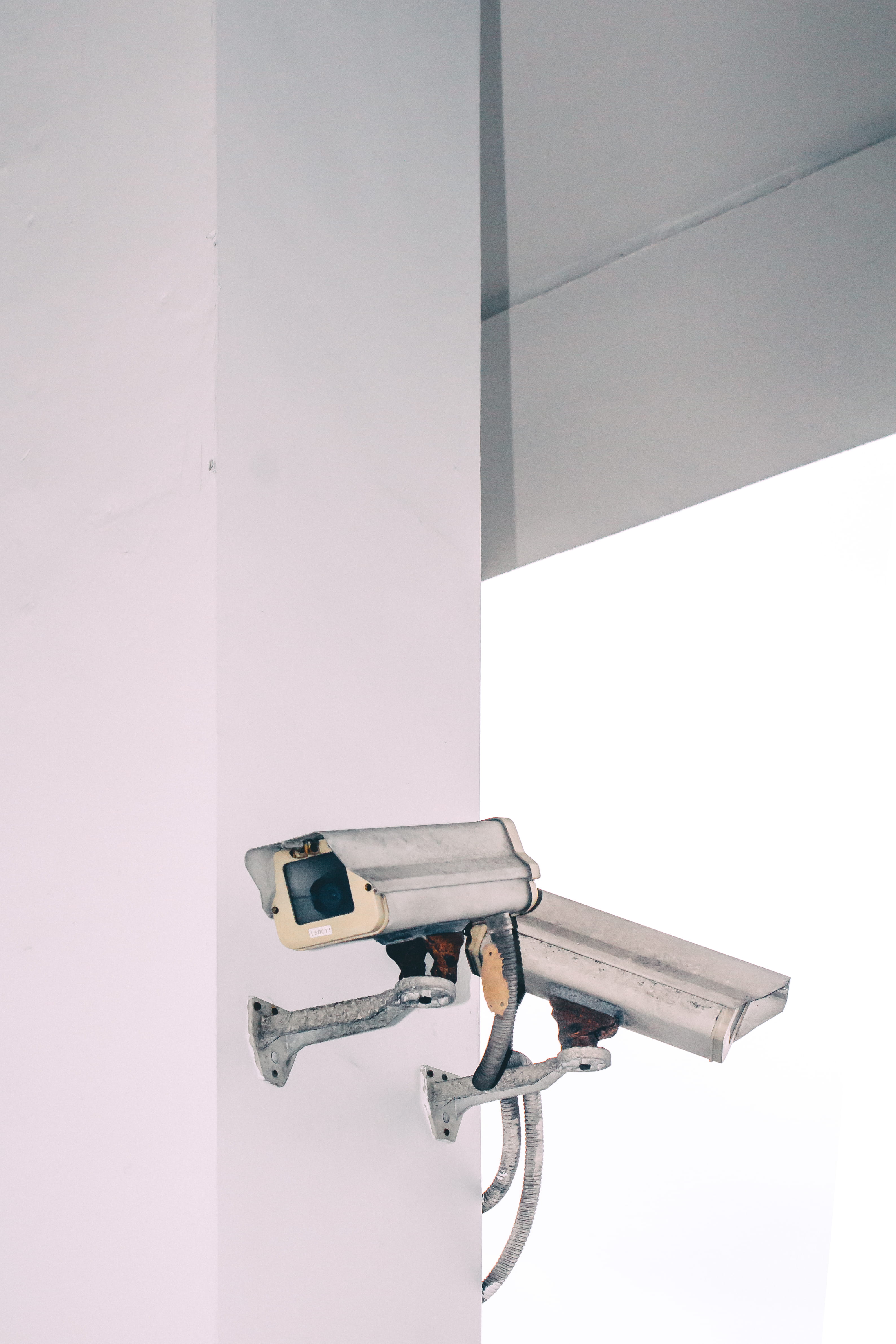 two bullet security camera attached on wall, white CCTV camera on wall