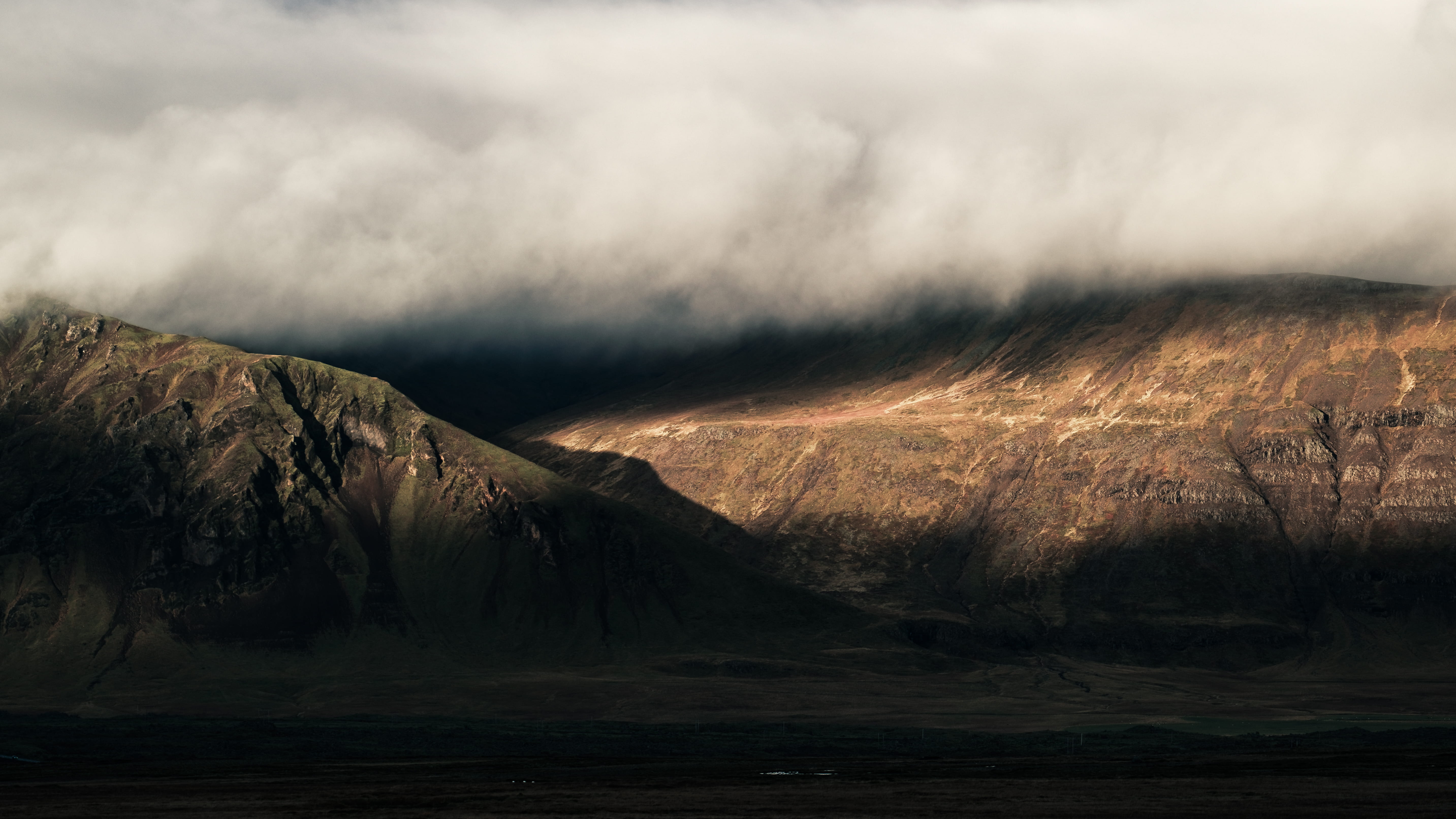 brown rocky mountain under white clouds, mountain under cloud