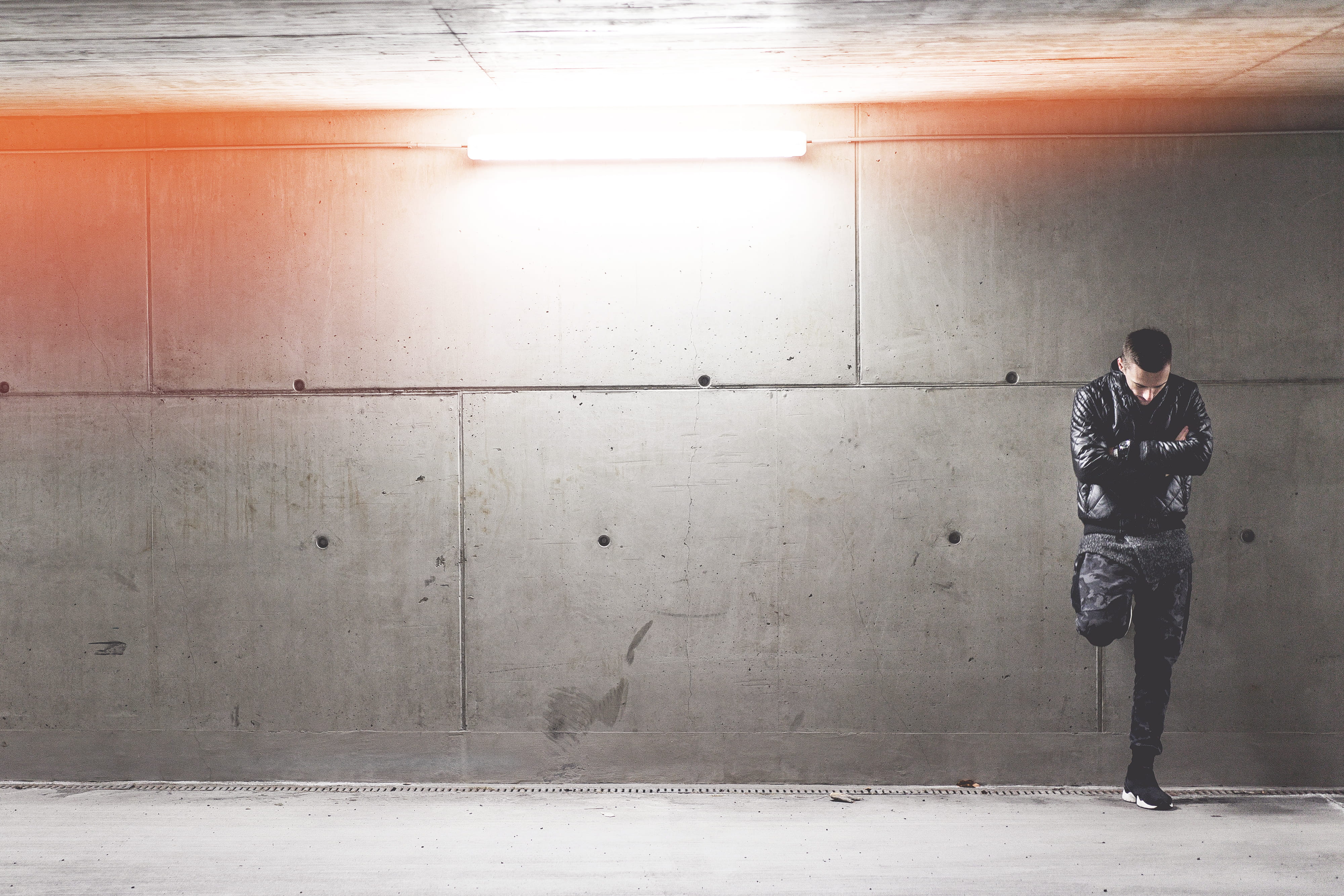 Young Man Standing In Front of Concrete Wall, architecture, dark