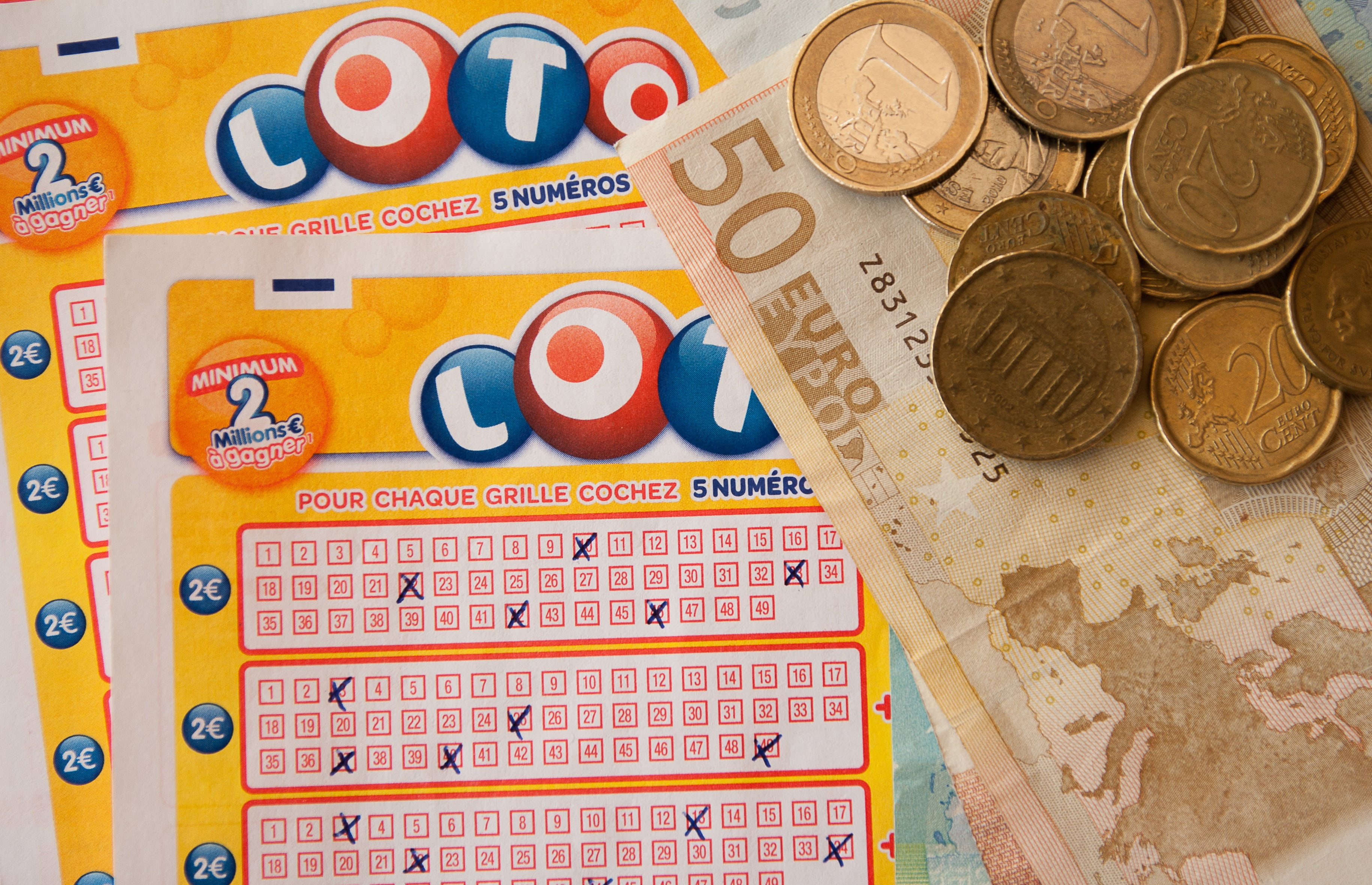 two yellow Lotto cards beside coins and banknote, games, random