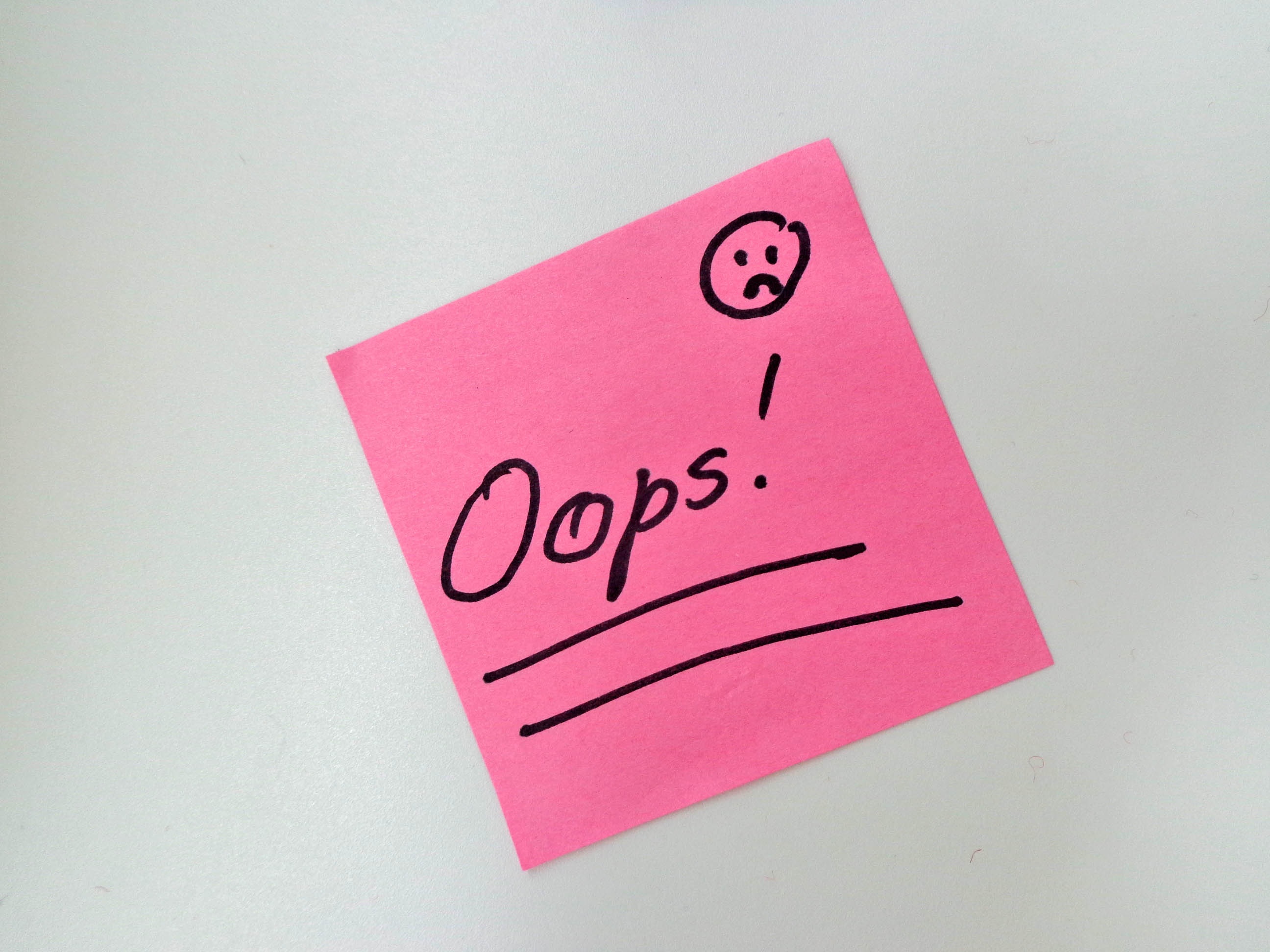 pink and black Oops! printed sticky note, surprise, smiley, western script