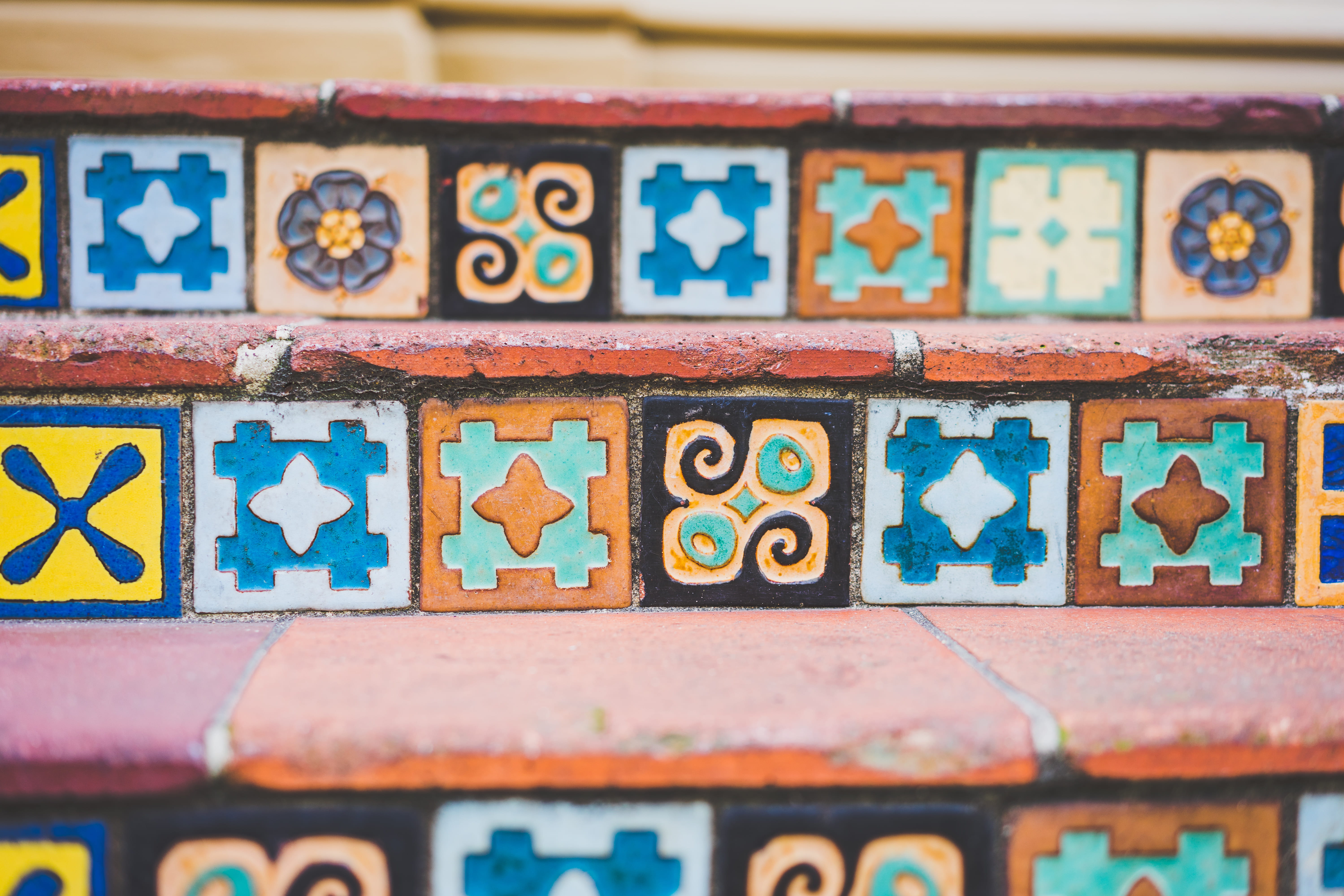 orange stair, brown and multicolored printed wall, tile, pattern