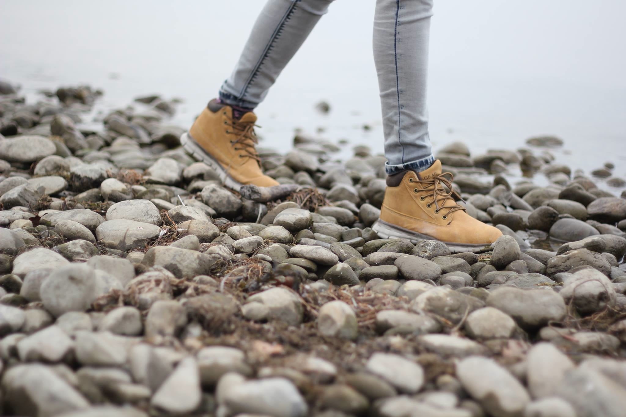 person walking on rocks, hiking, hiking shoes, hiking boots, walking shoes