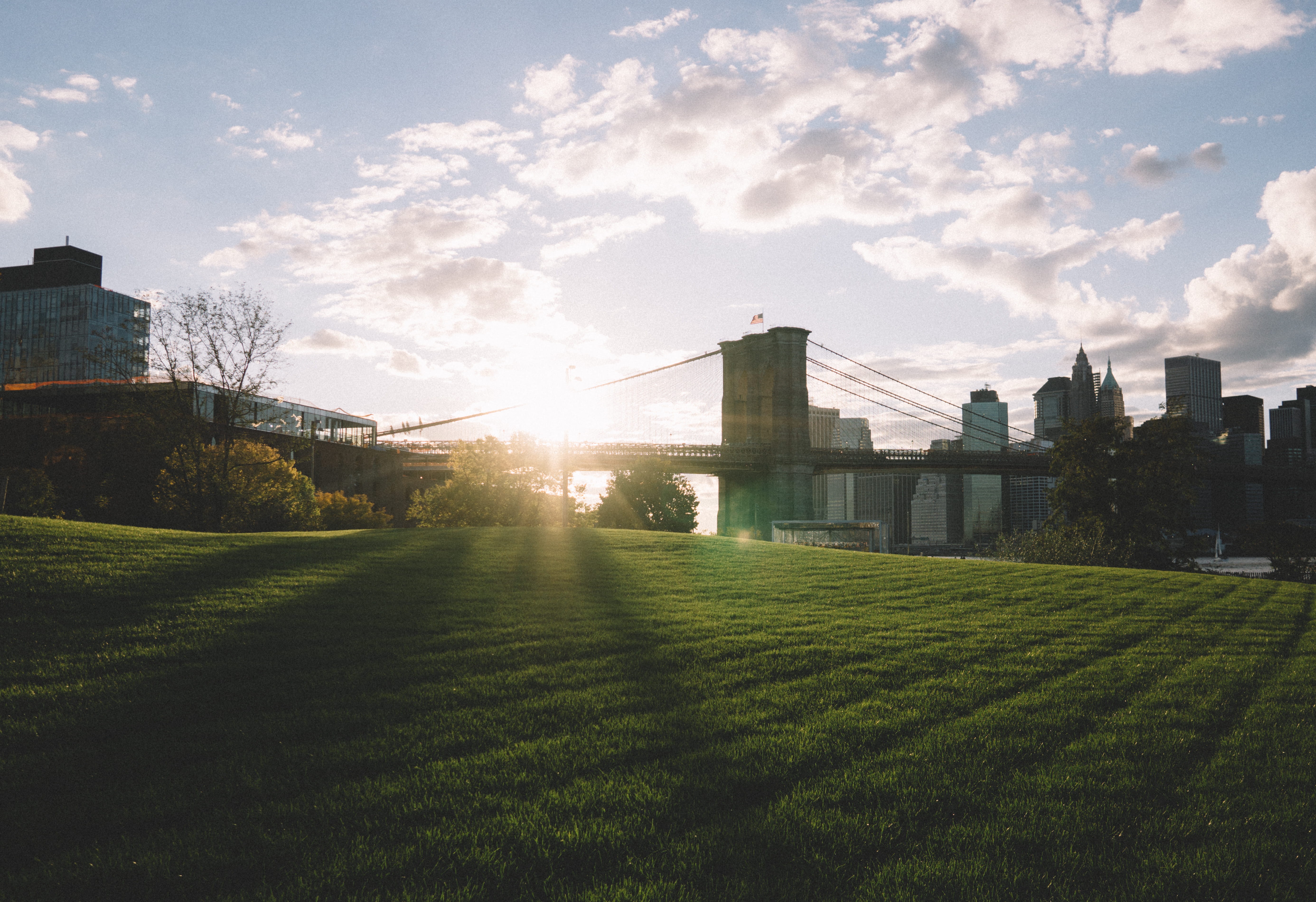 Brooklyn bridge during daytime, green grass field during daytime
