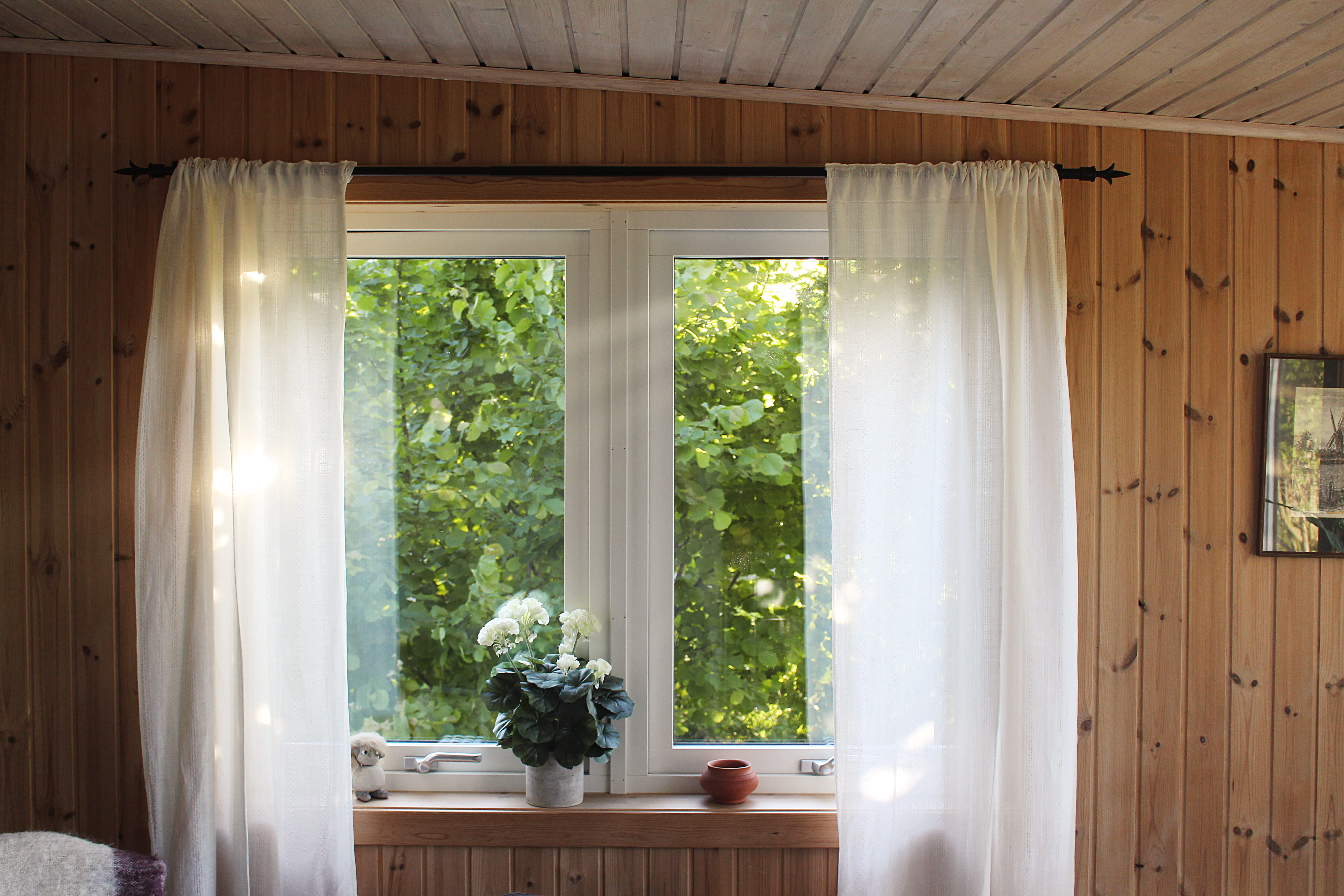 white rod pocket curtain on window frame, two white curtain windows
