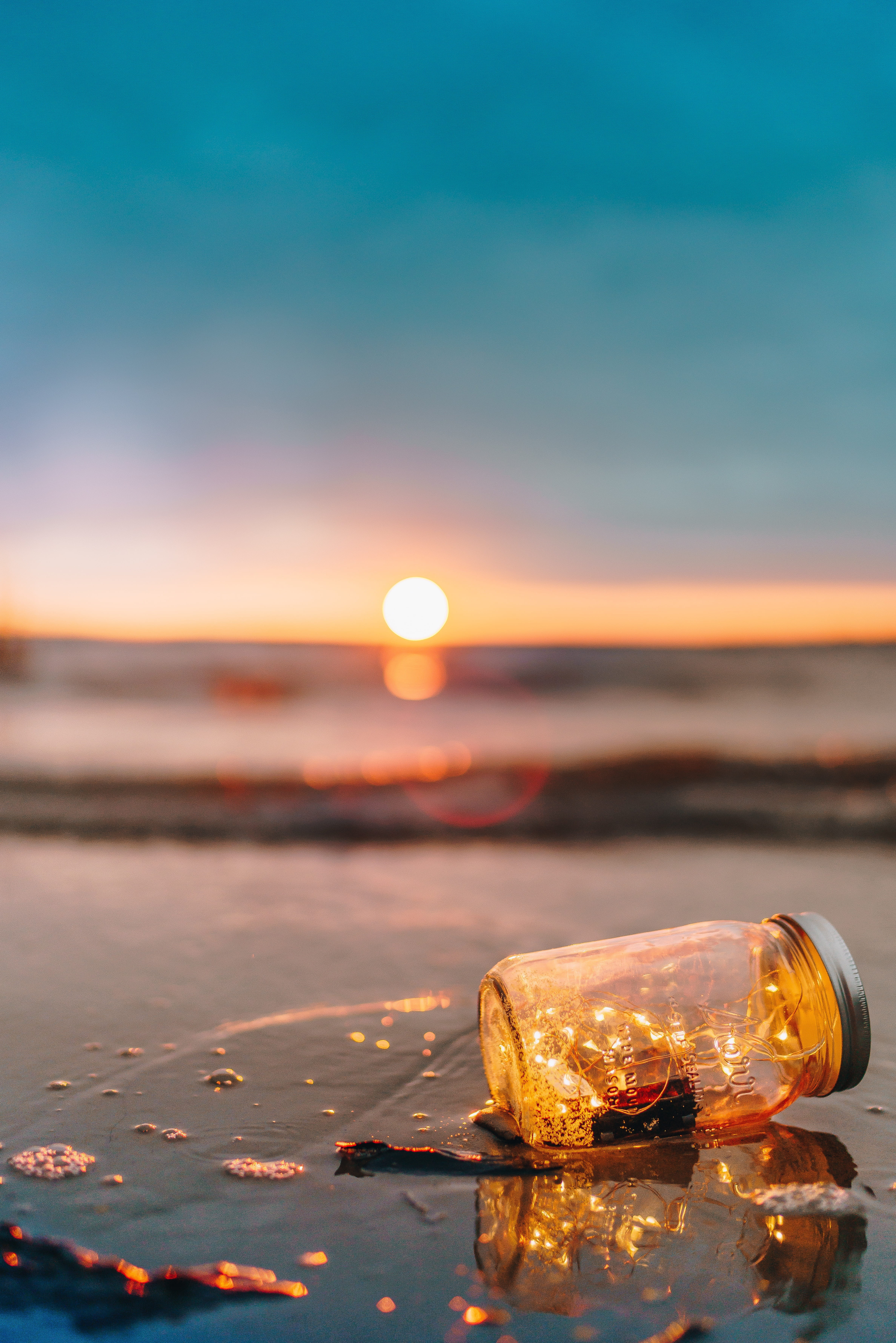 glass mason jar, string, lightd, beach, sea, water, reflection