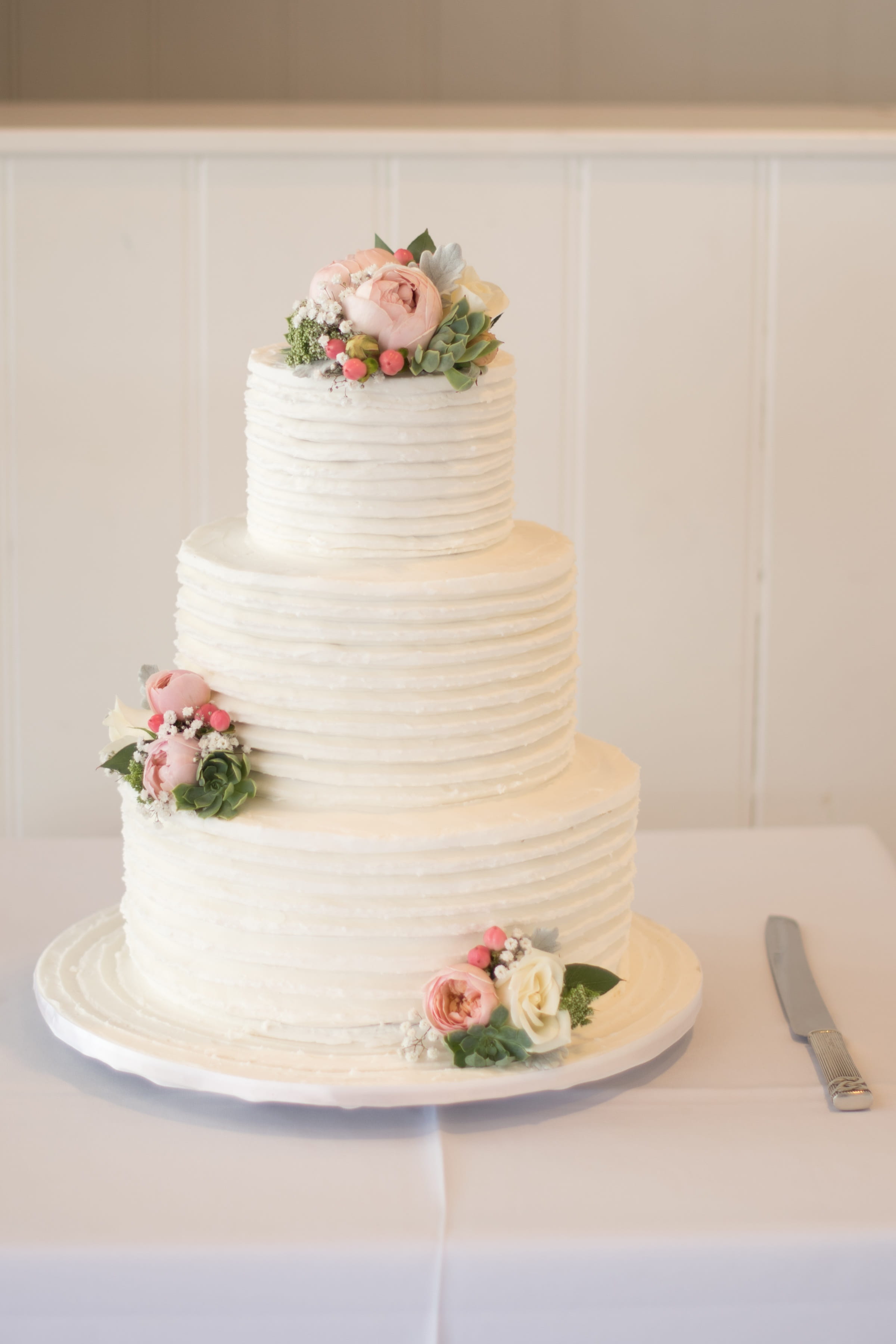 three tier floral cake near cake slicer, wedding, wedding cake