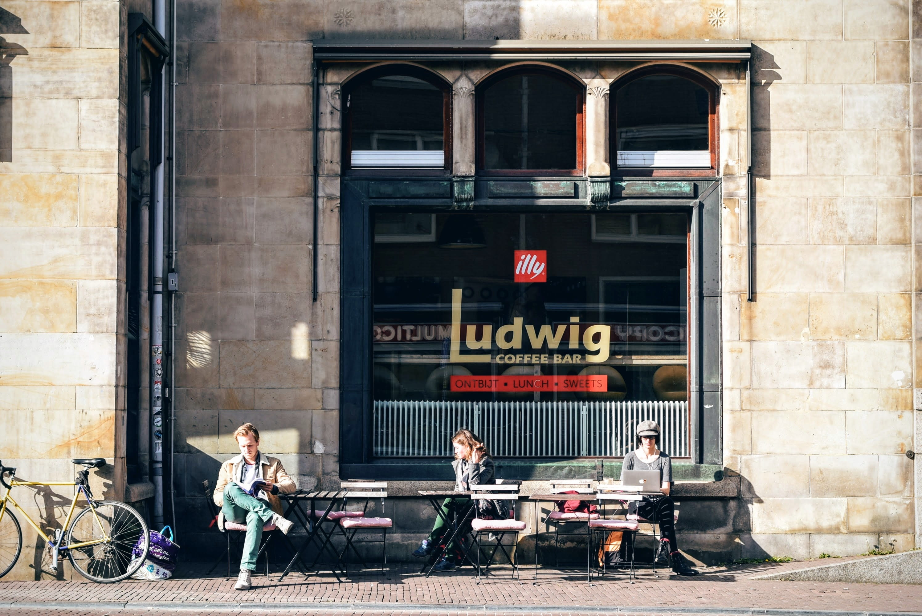 photo of three people sitting in front of Ludwig coffee, architecture
