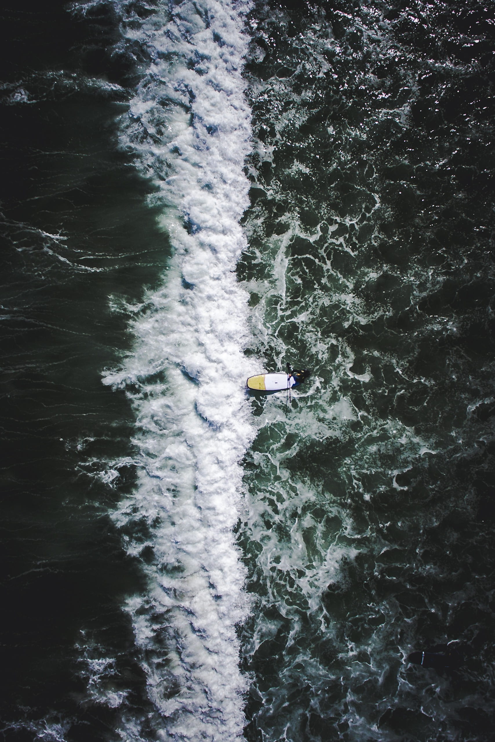Abstract waves, person standing on surfboard near oceanwaves