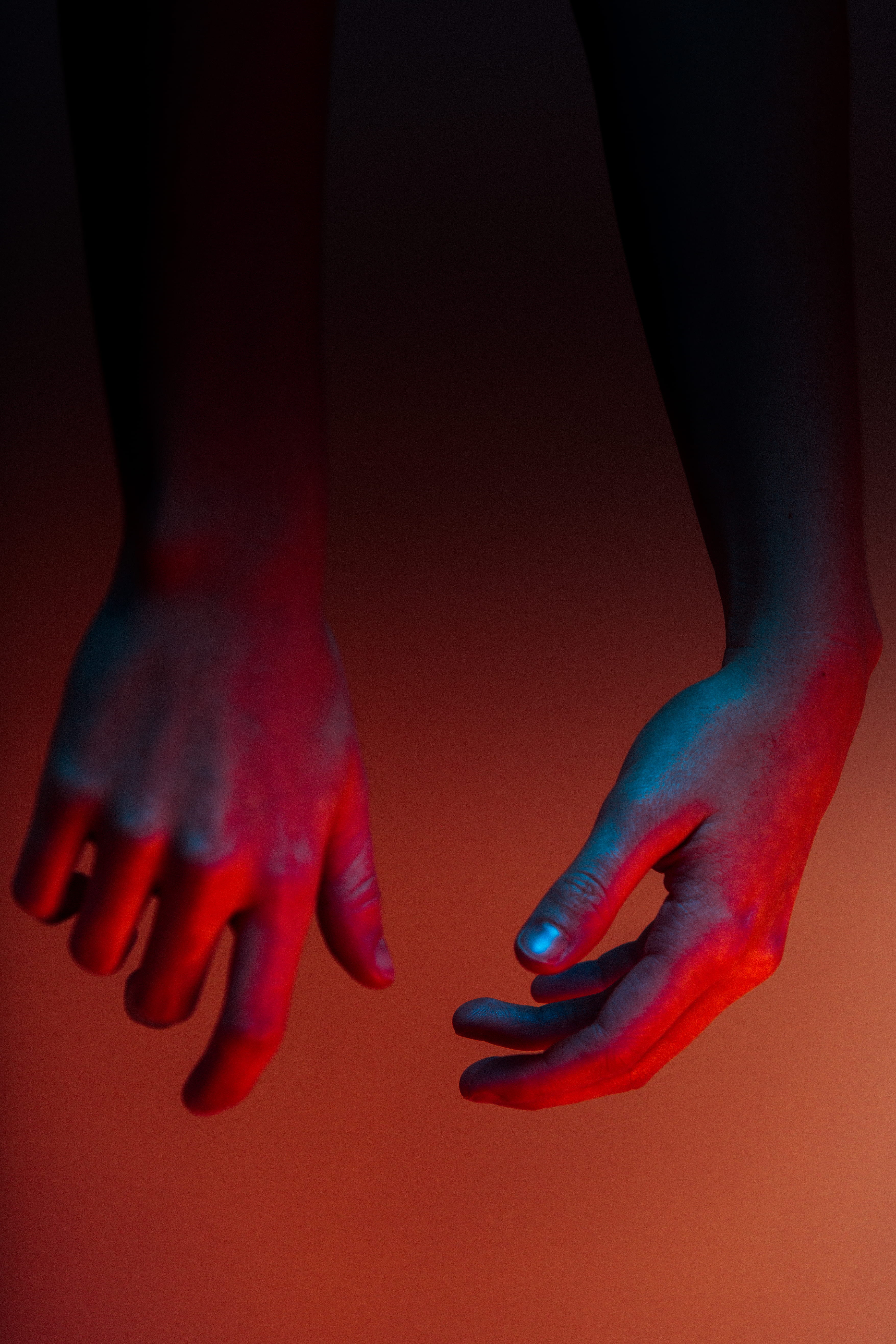 photo of person's hands, person's hands, blue, red, color, moody
