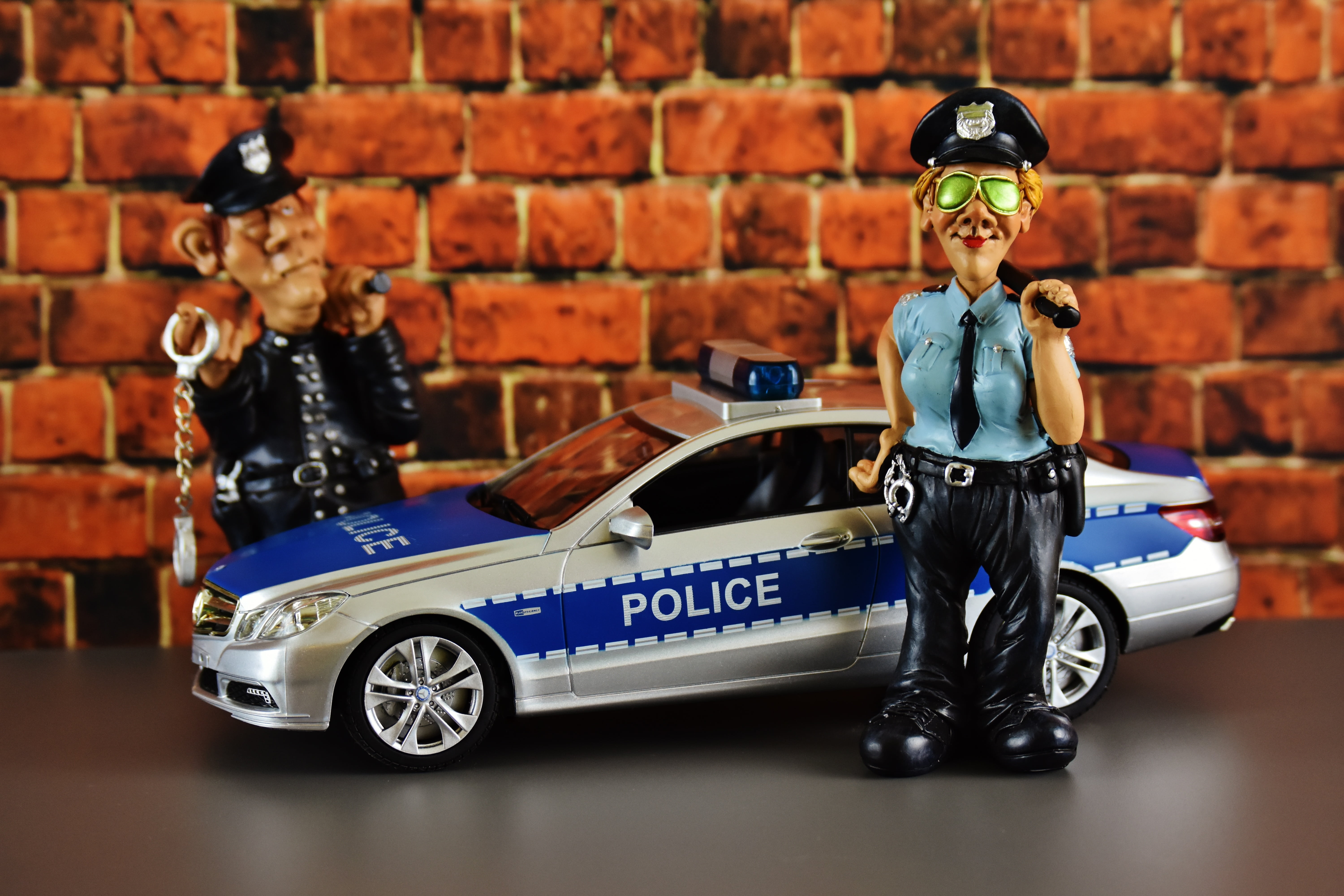 white and blue police car and two policemen toys, police officers