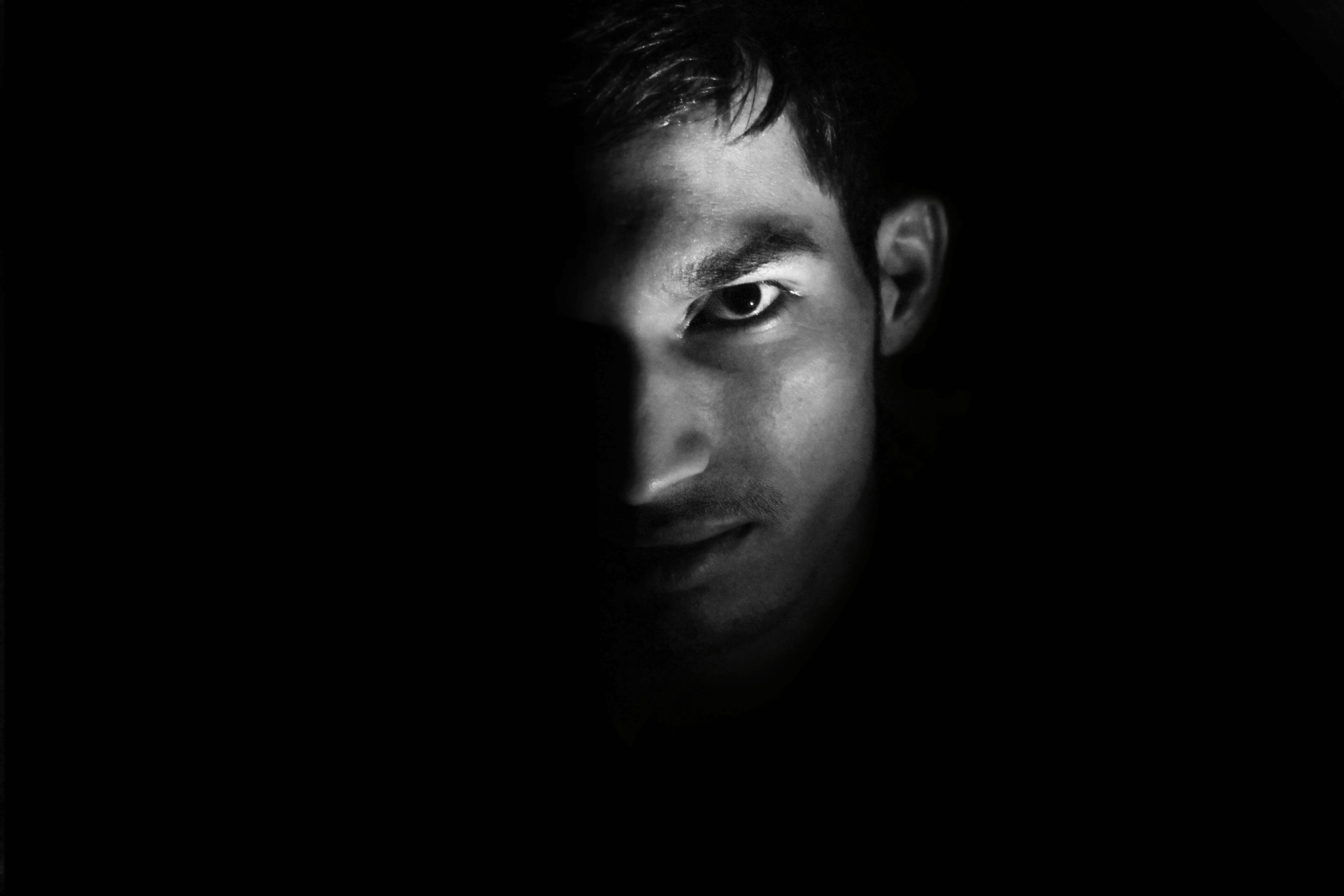 closeup photography of man's face, black and white, dark, boy