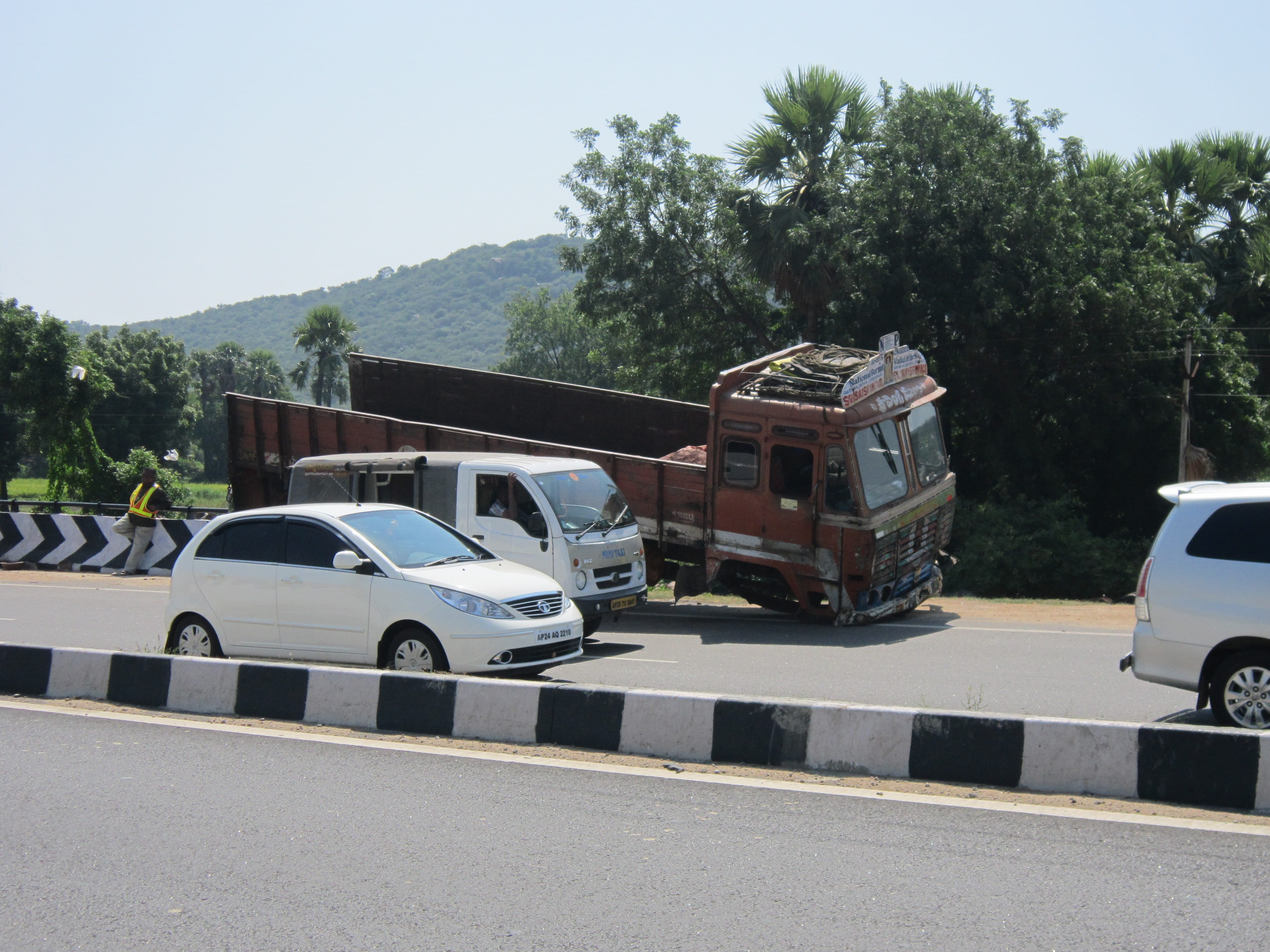 orange dump truck parked beside road, highway, accident, traffic