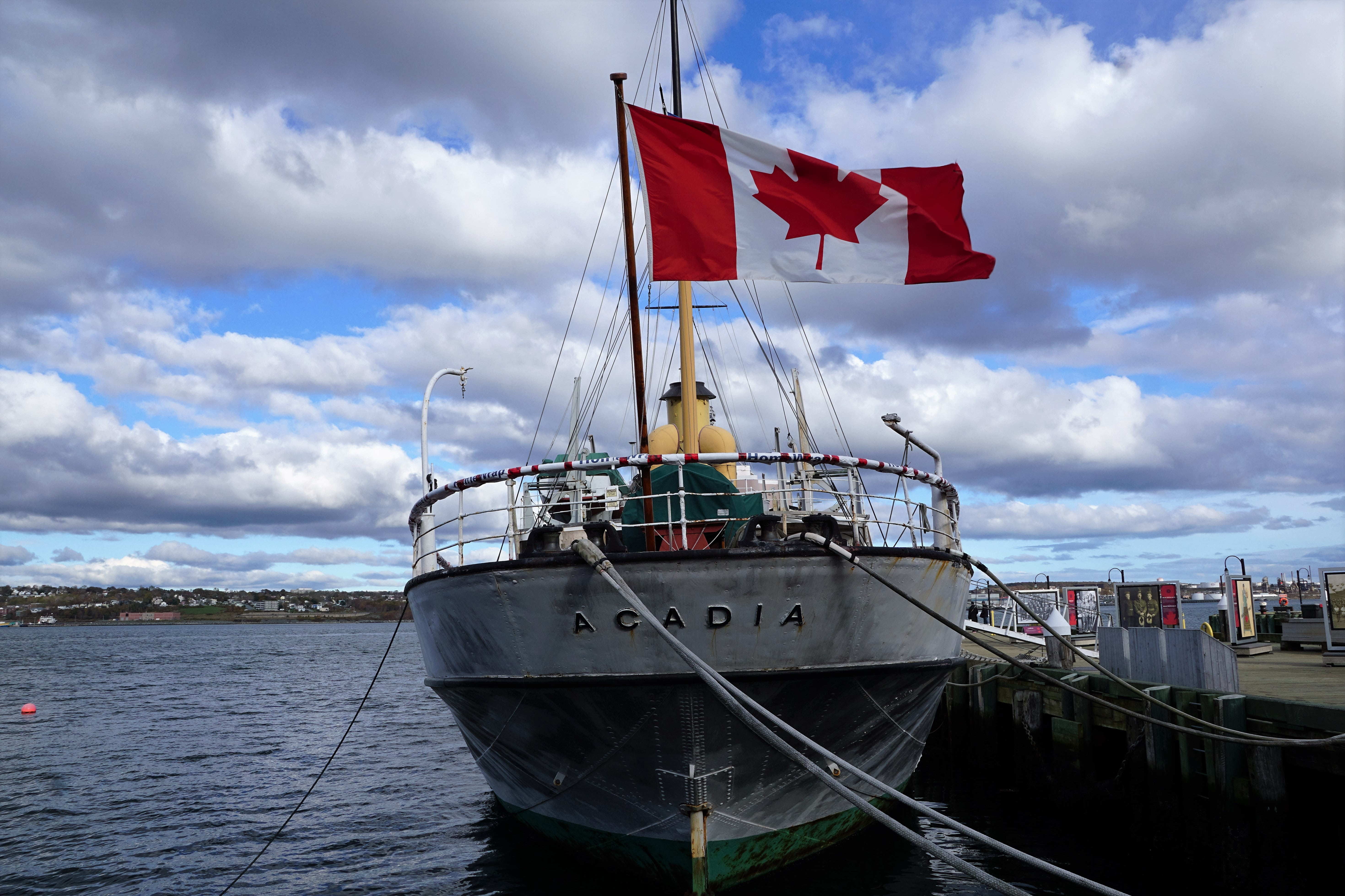 gray Acadia boat on sea with Canada flag during daytime, boot