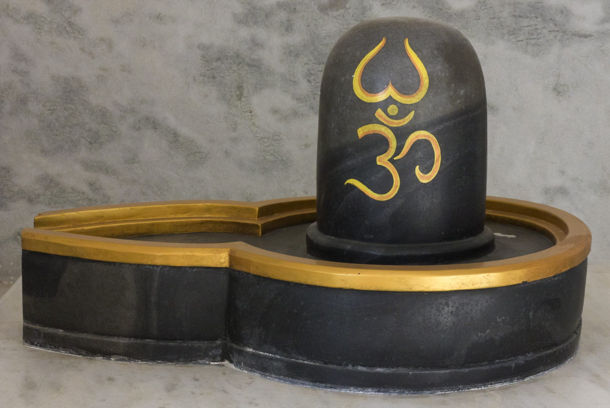 close-up photo of black and brown wooden lingam altar, shivling