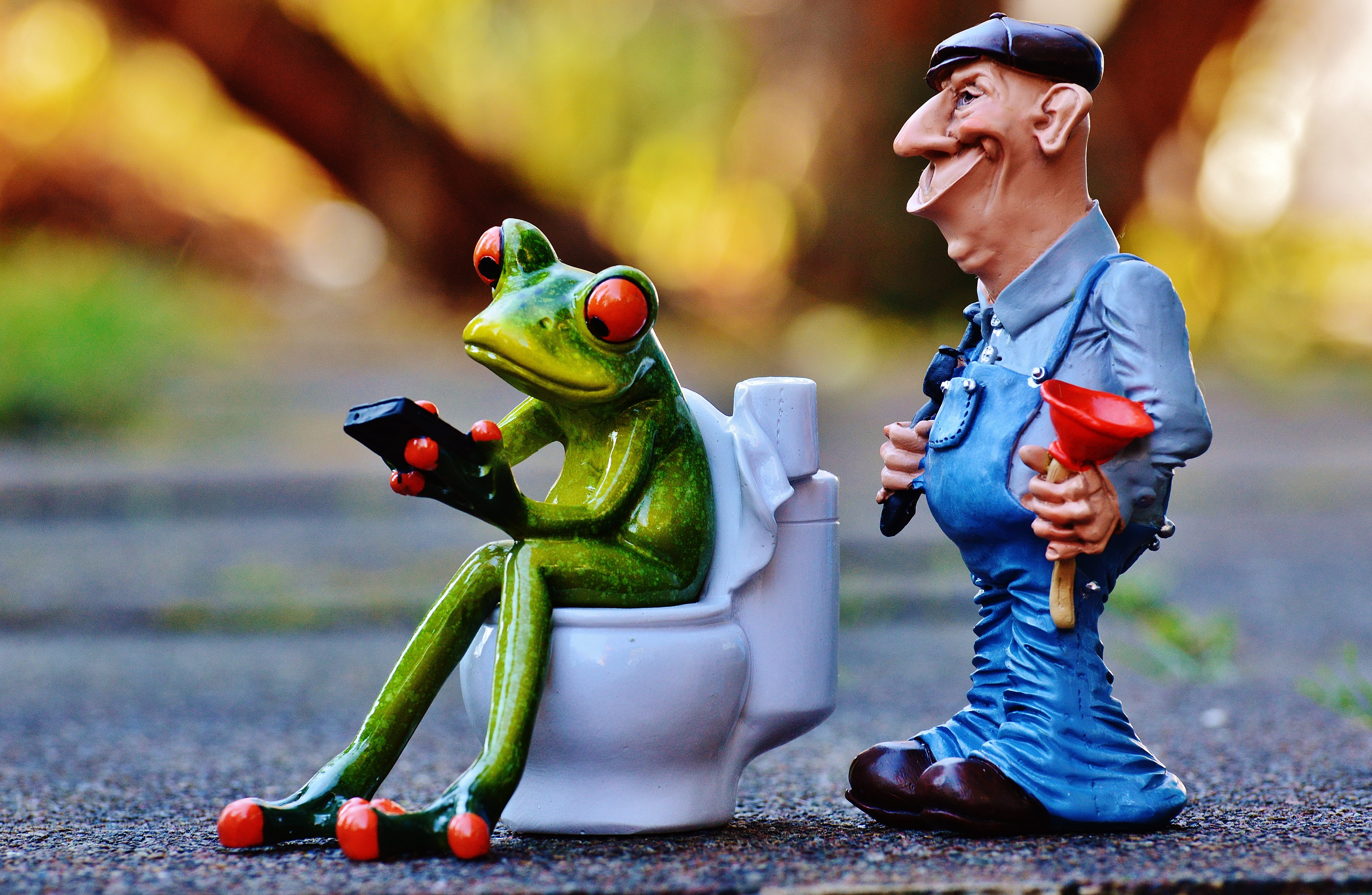 selective focus photography of two Kermit the frog and man figurines