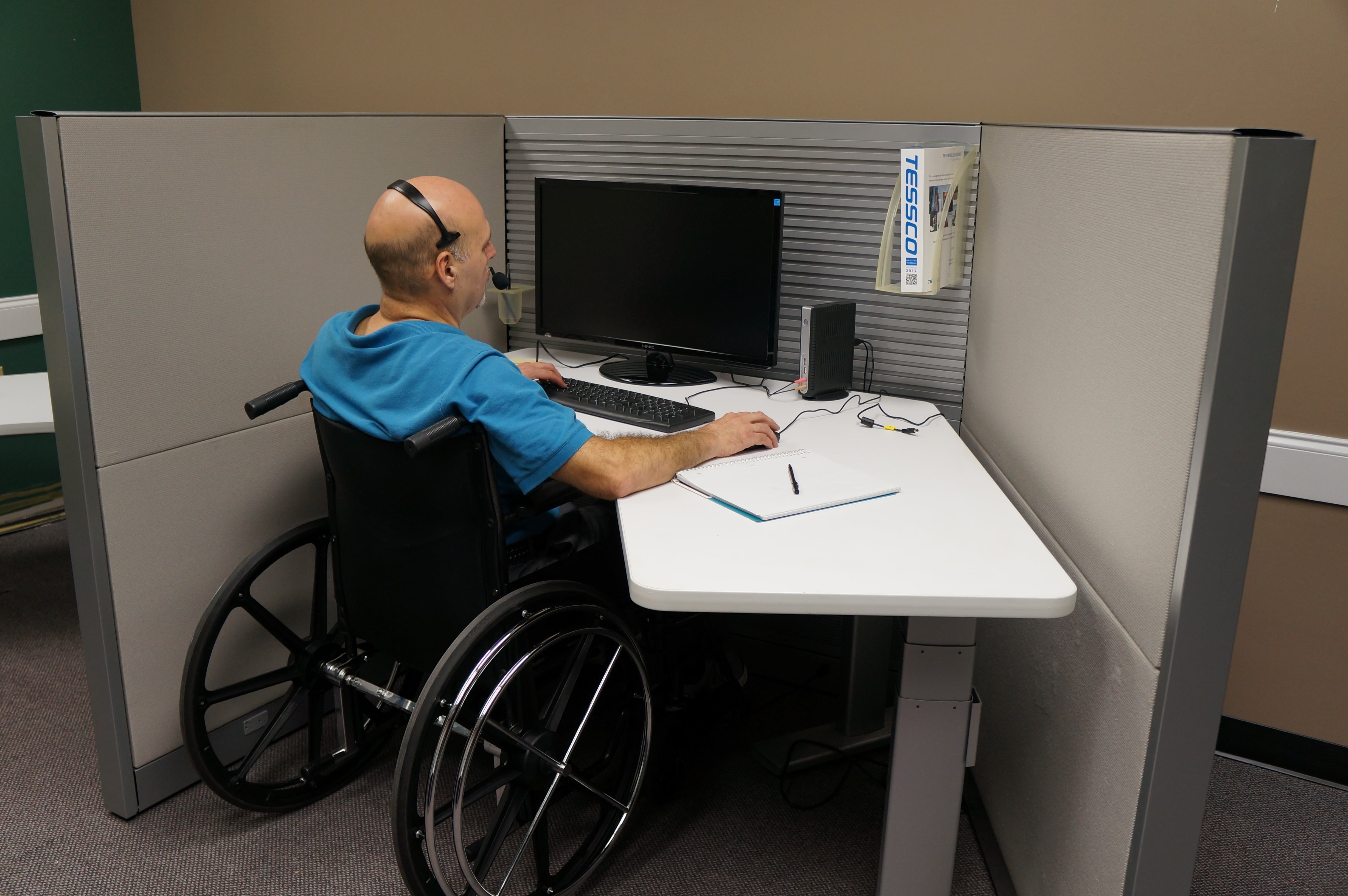 man on wheelchair using computer, disabled, veteran, call, center