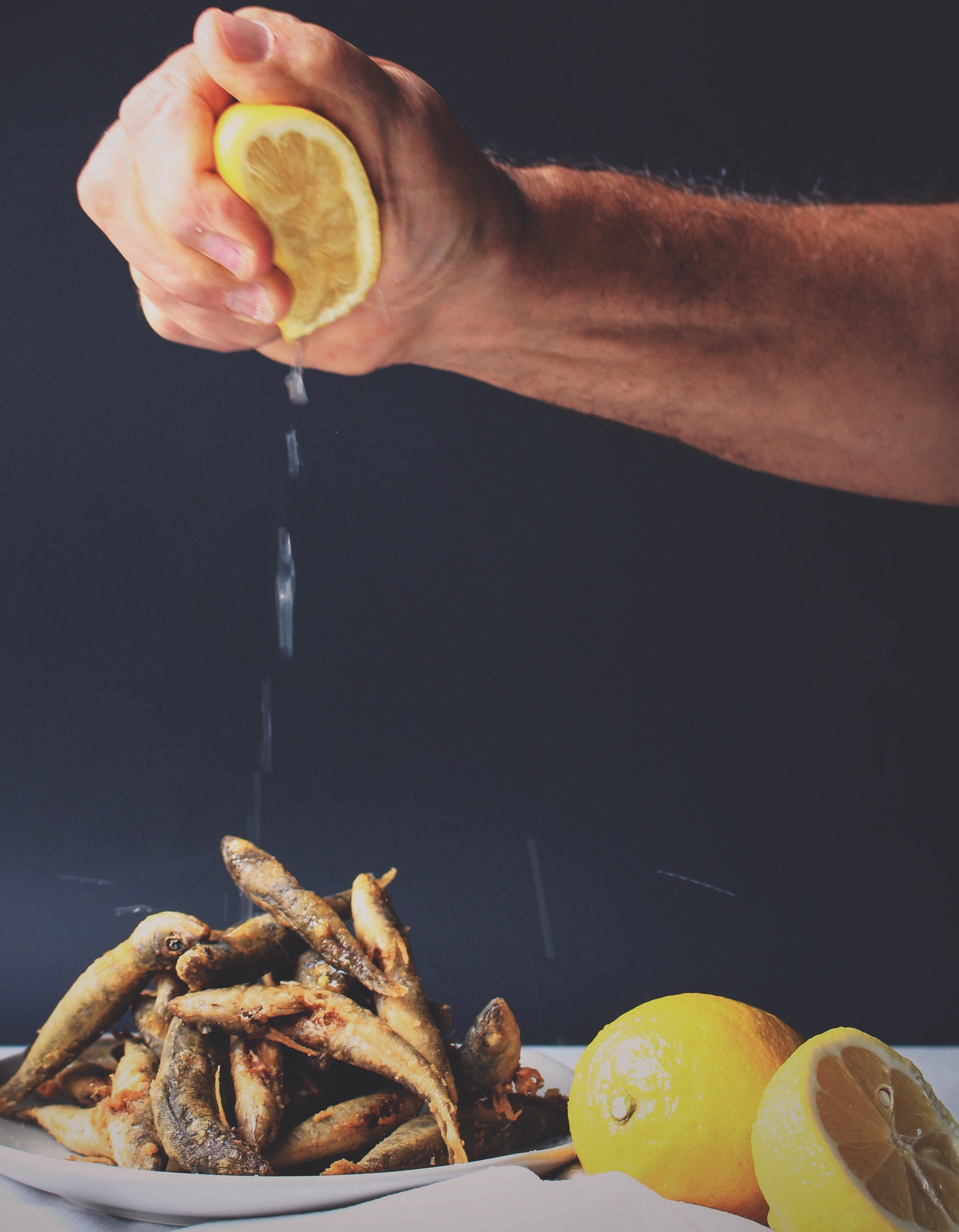 person squeezing lemon on fried fishes, food, human Hand, freshness