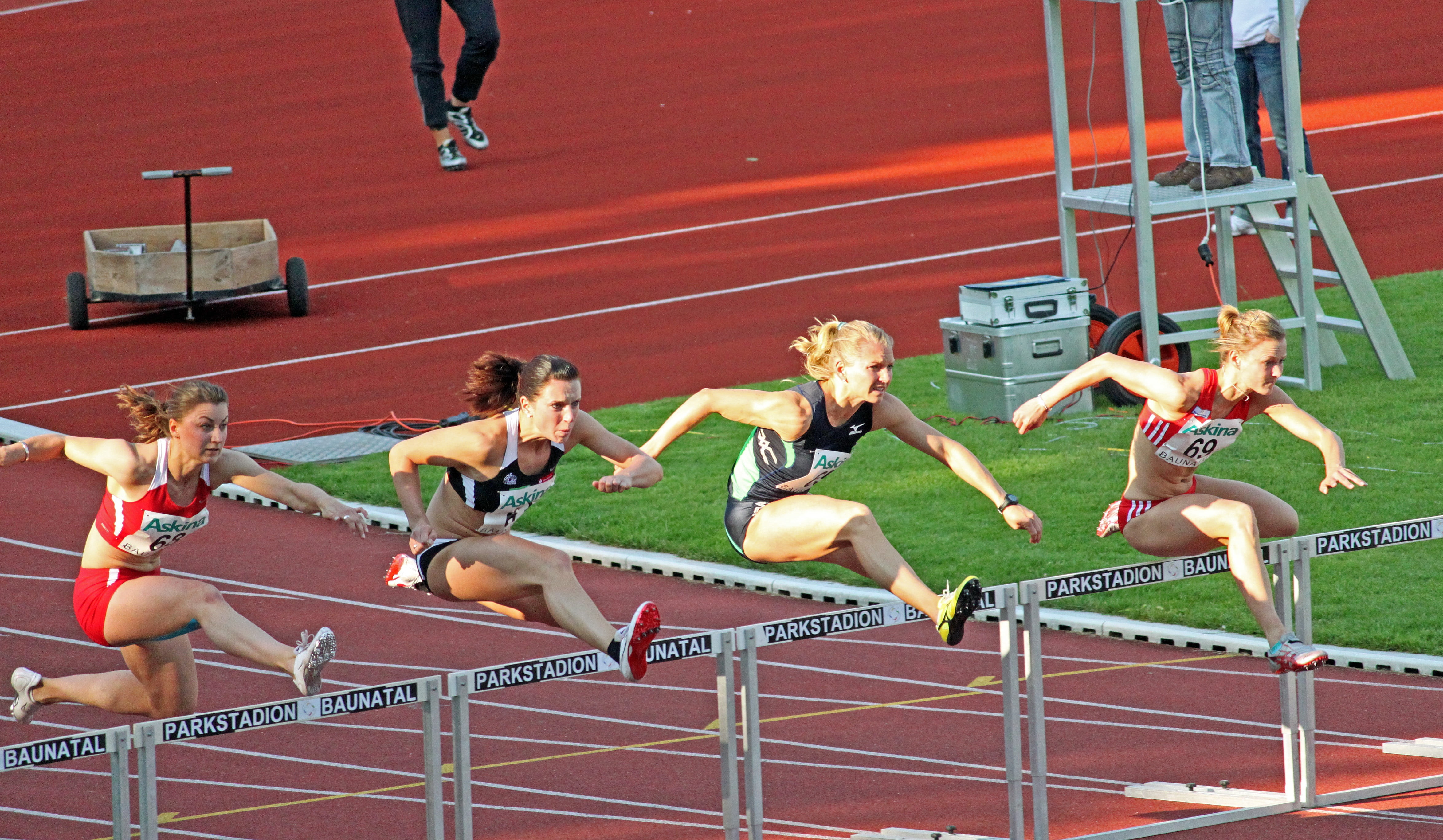 four women jumping, athletics, sport, hurdles, sprint hurdles athlete