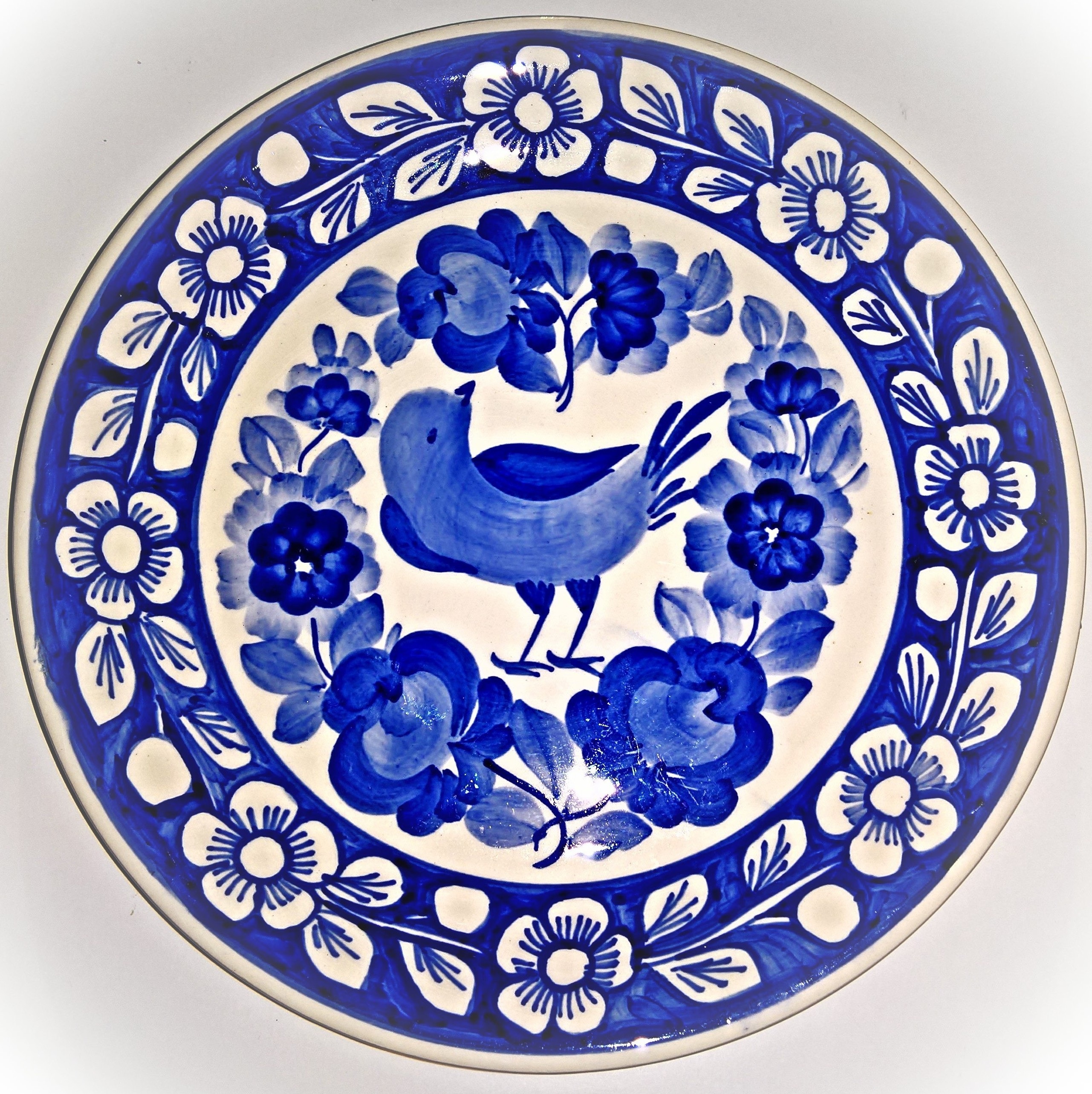 closeup photo of white and blue bird-printed plate, porcelain plate
