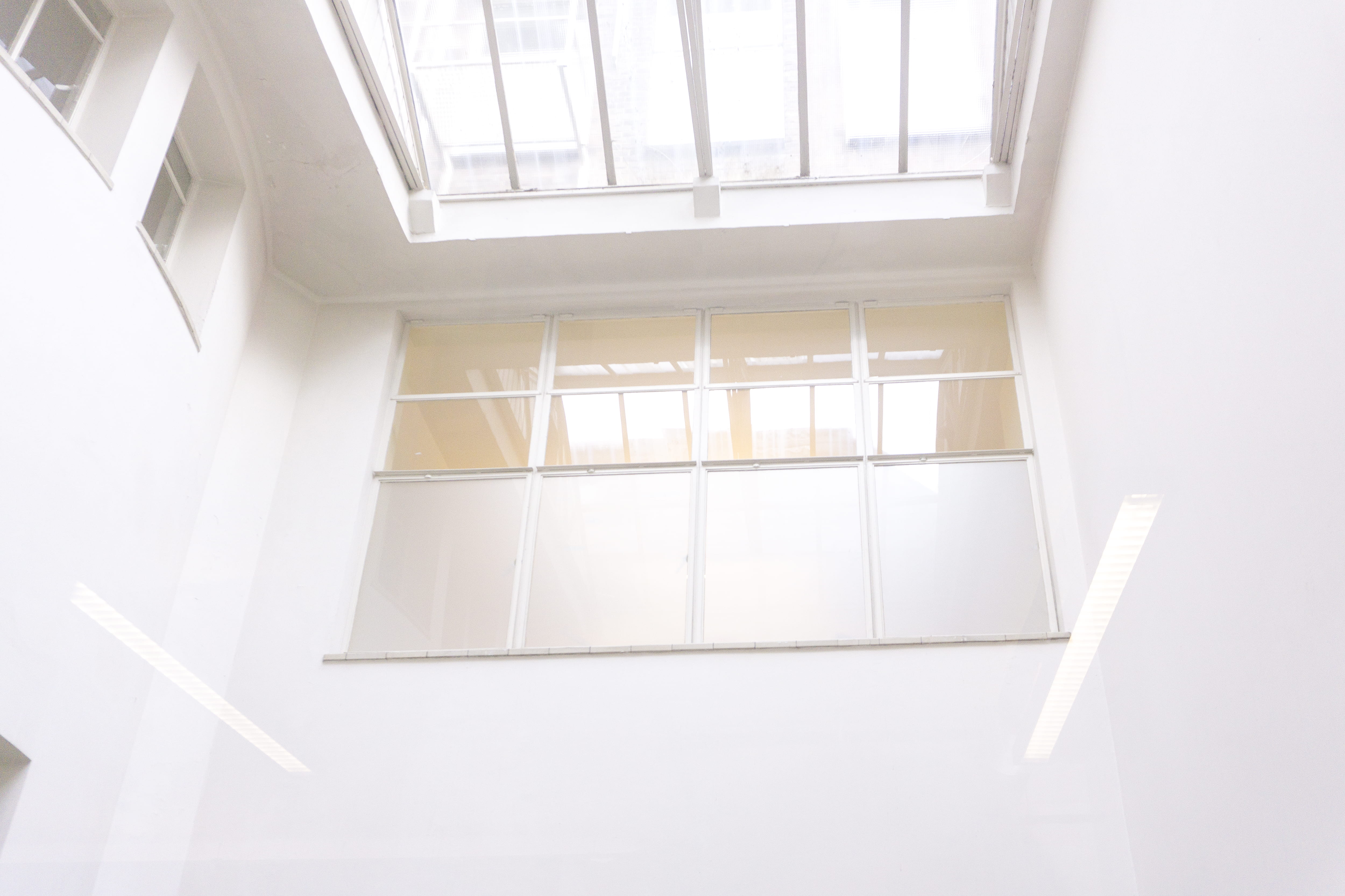 closed clear glass window, white painted wall, ceiling, frame