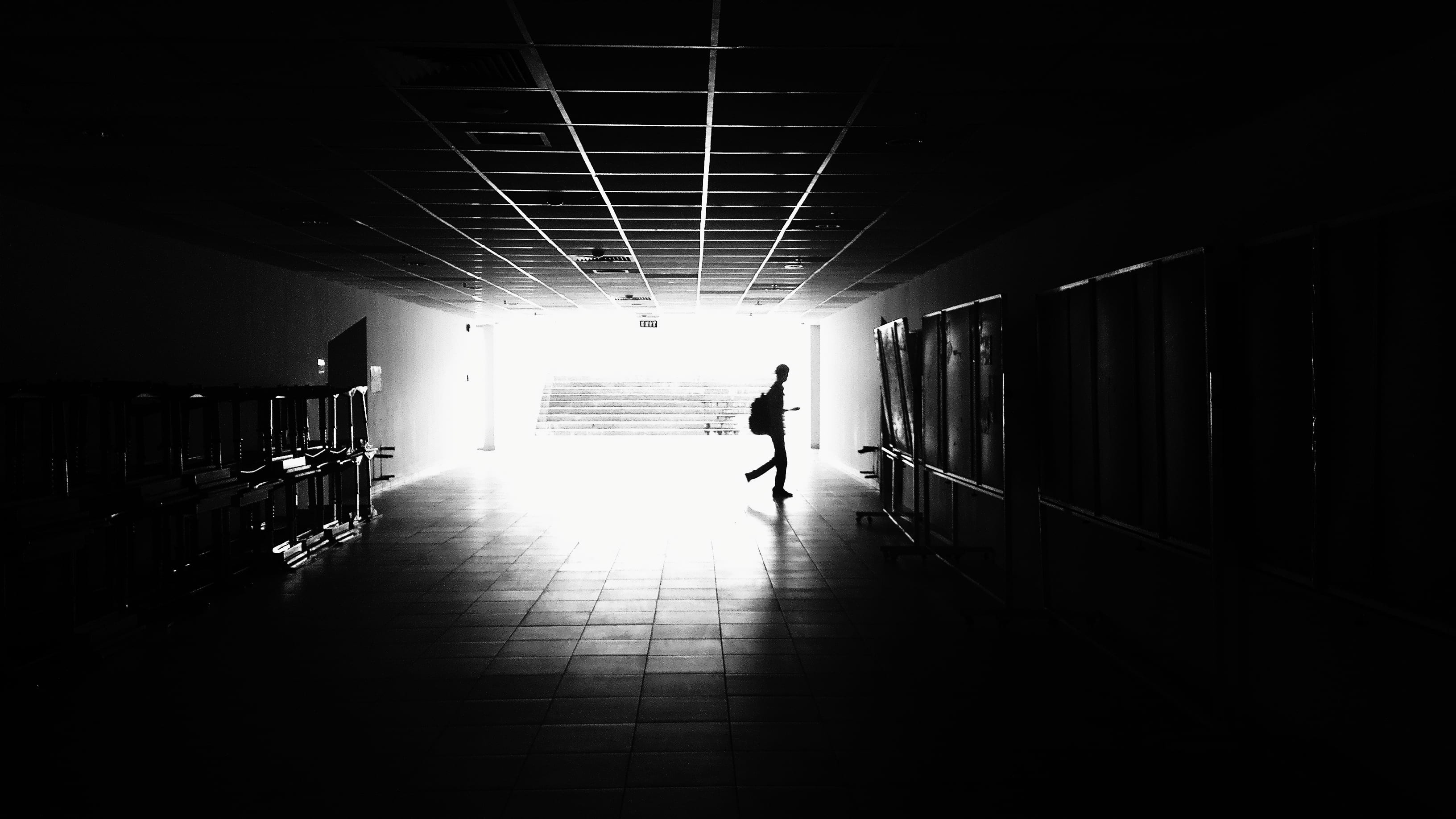 Silhouette of Man Walking on Hall, architecture, black-and-white