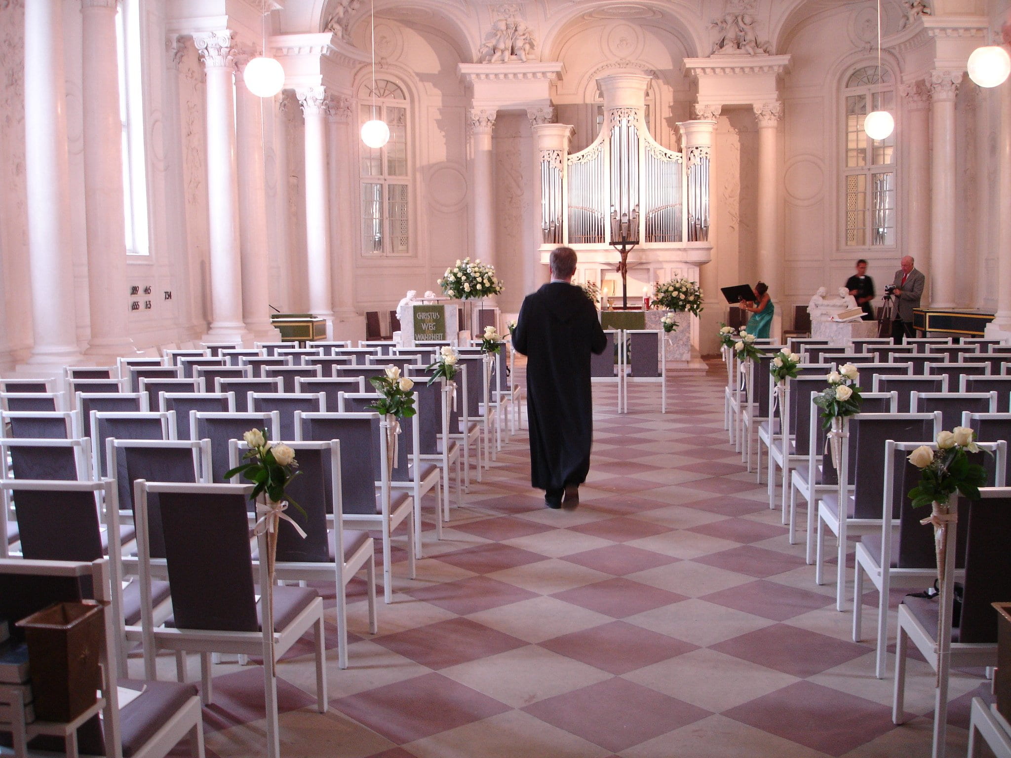 person walking in front of altar, church, pastor, wedding, celebration