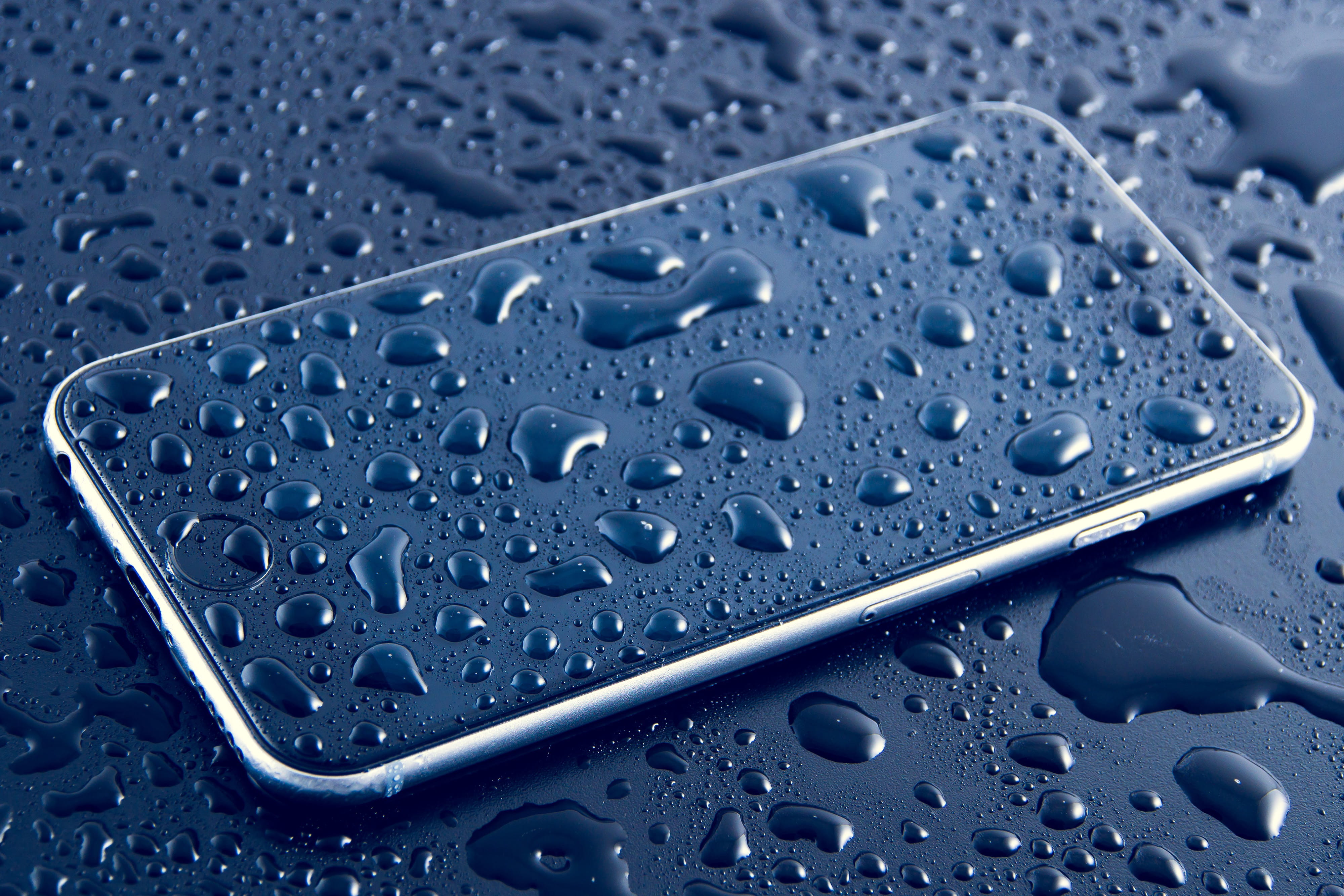 Wet mobile iPhone smartphone with water drops, technology, business