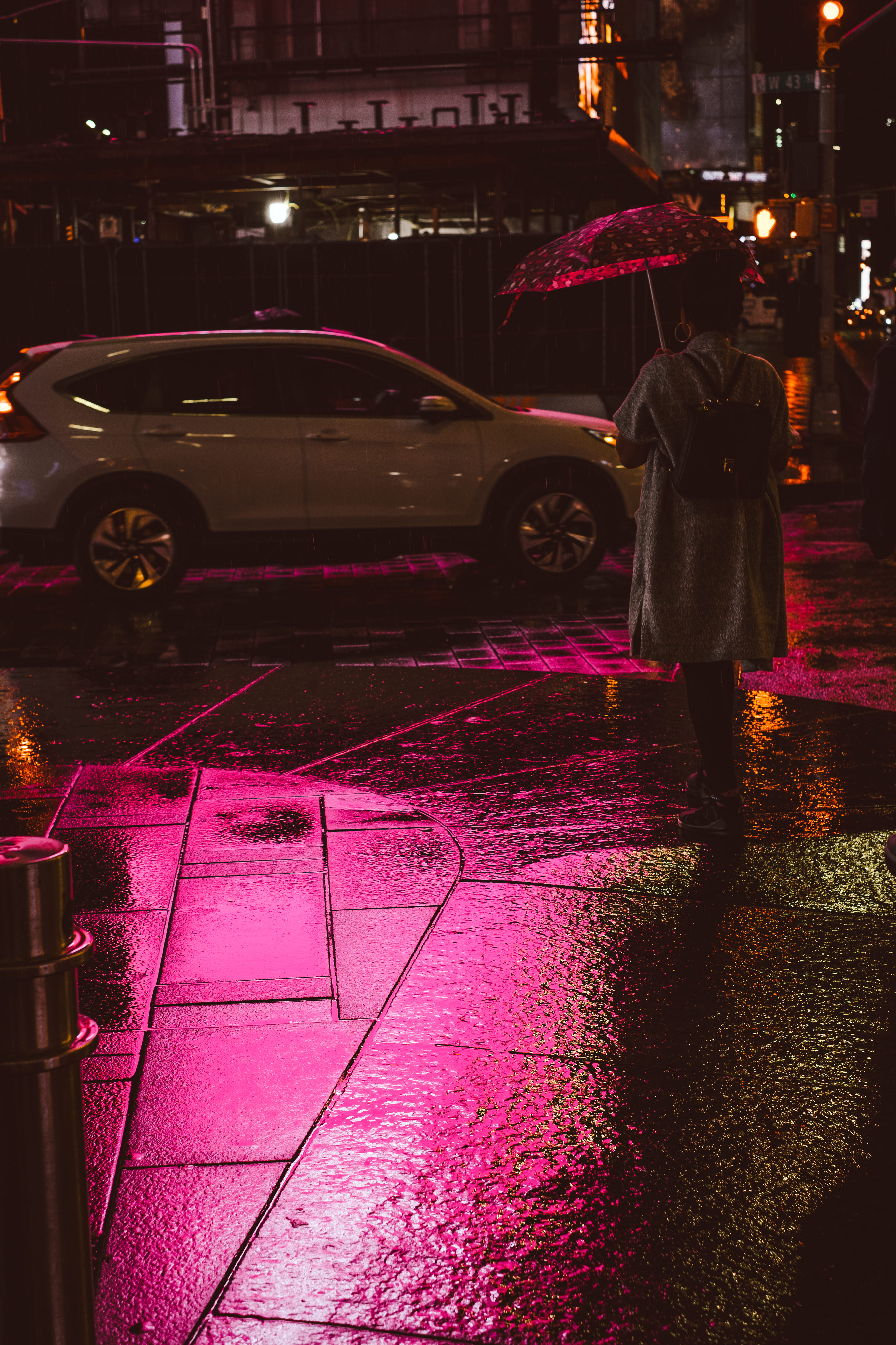 person holding umbrella while walking, woman holding open polka-dot umbrella facing backwards