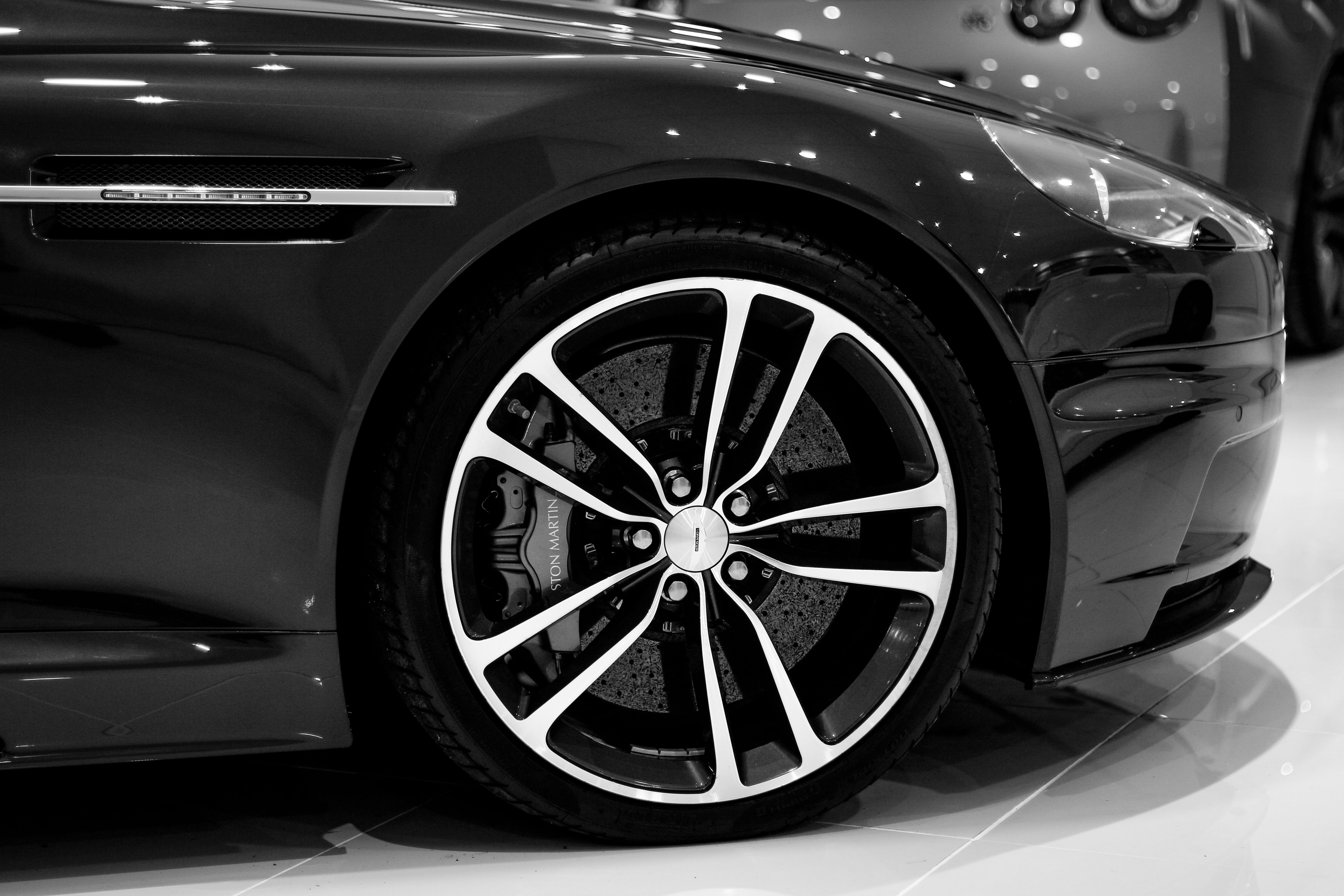 photography of chrome-colored 5-spoke vehicle wheel and tire