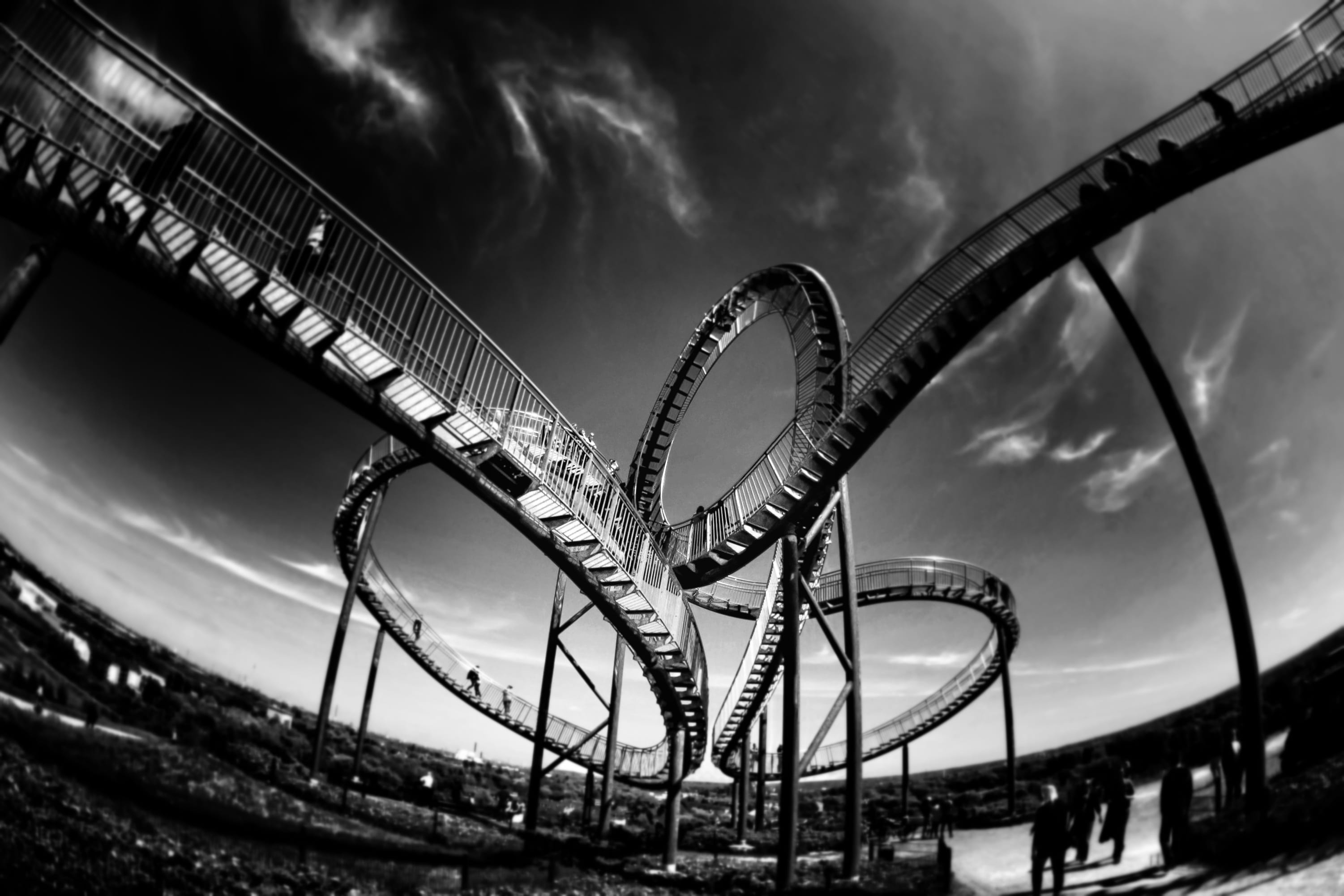 grayscale photo of bridge, rollercoaster, looping, amusement