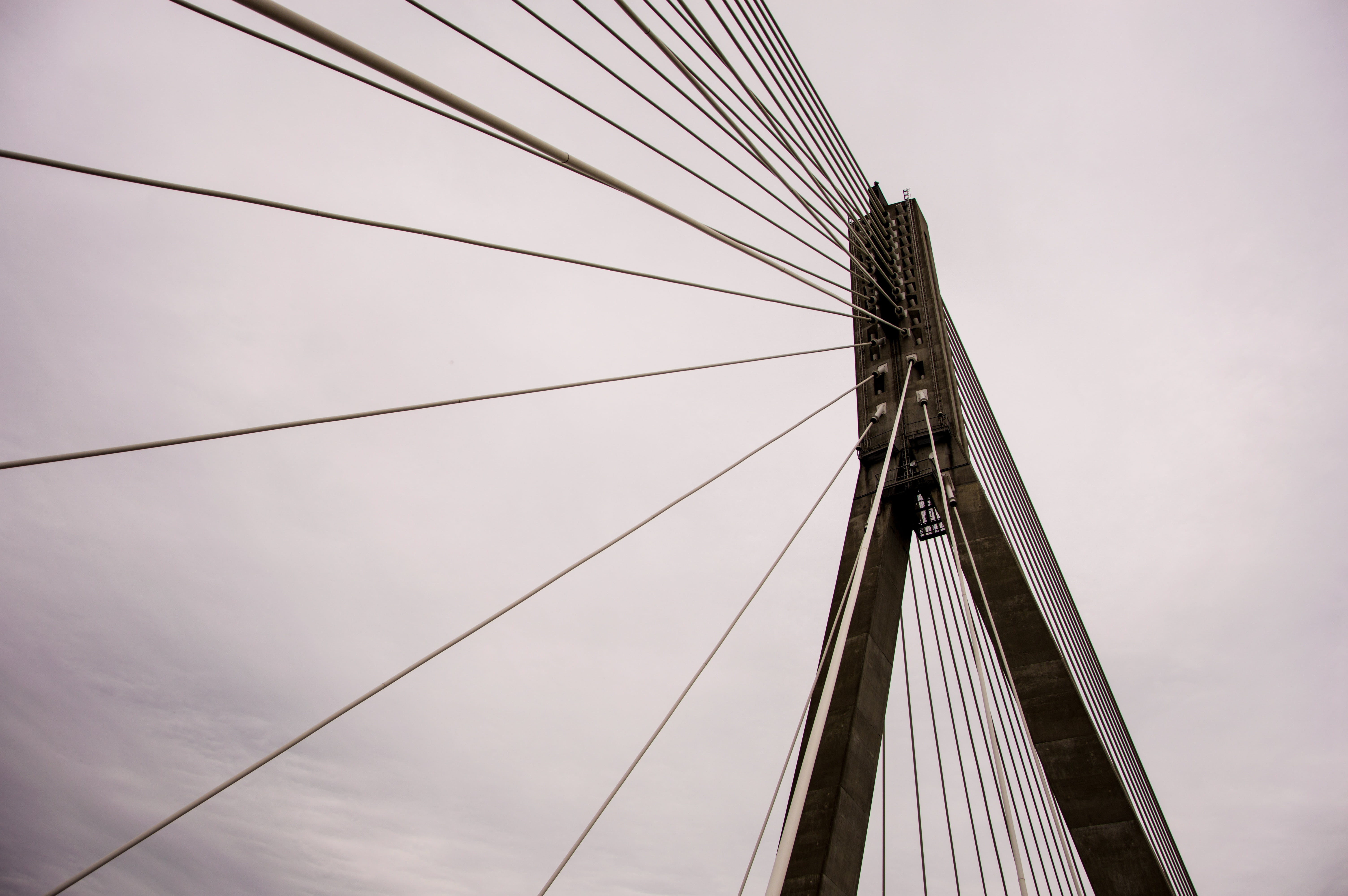 black bridge tower during daytime, bridge construction, sky, perspective