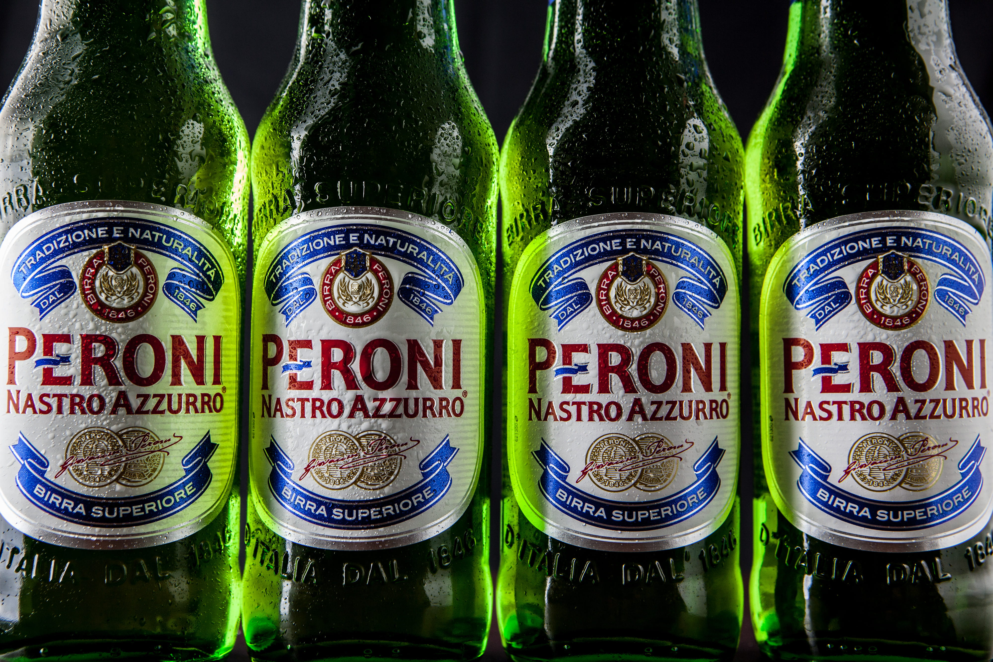 Close-up shot of green Peroni lager beer bottles, food/Drink