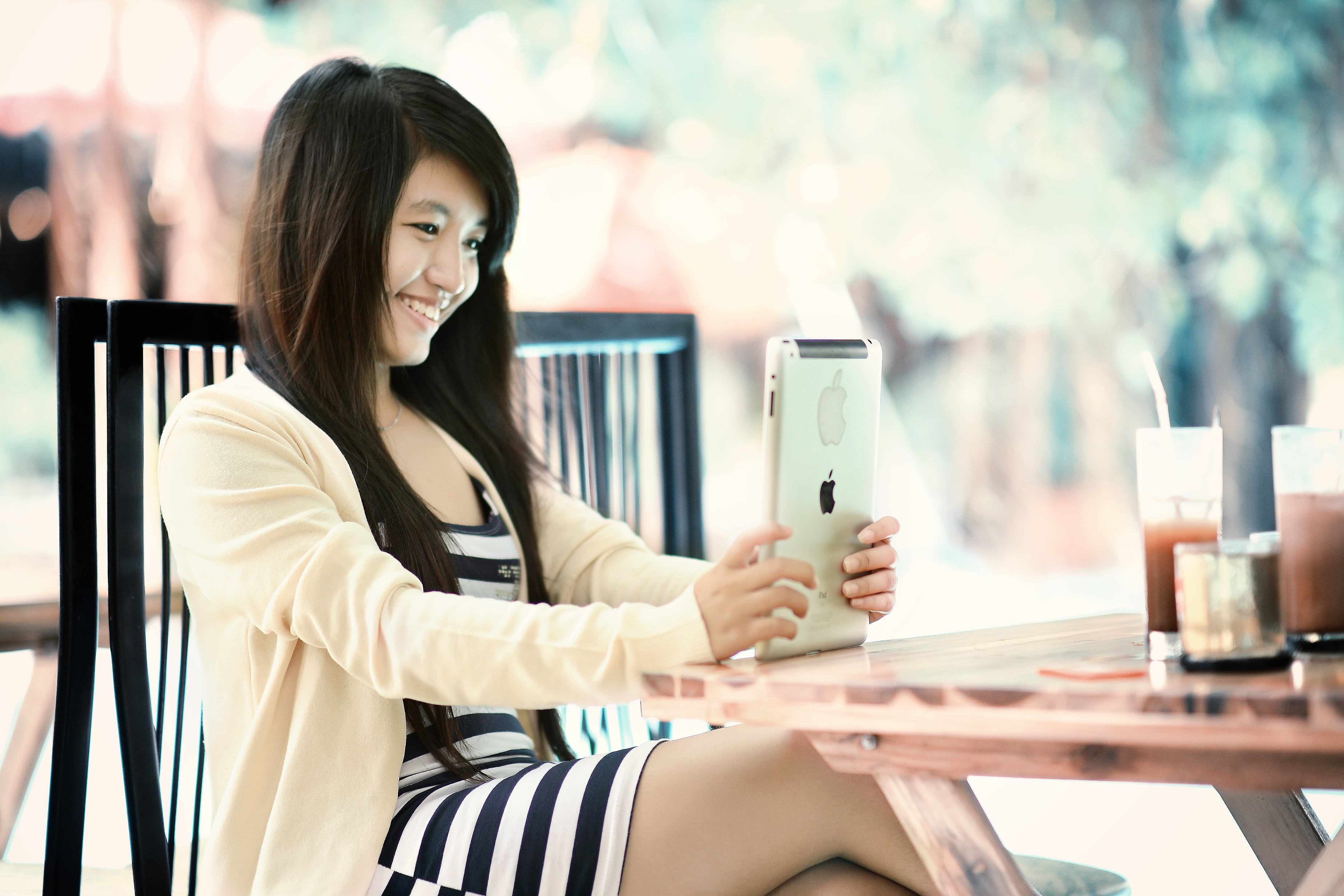 woman wearing white and black striped dress, ipad, girl, tablet