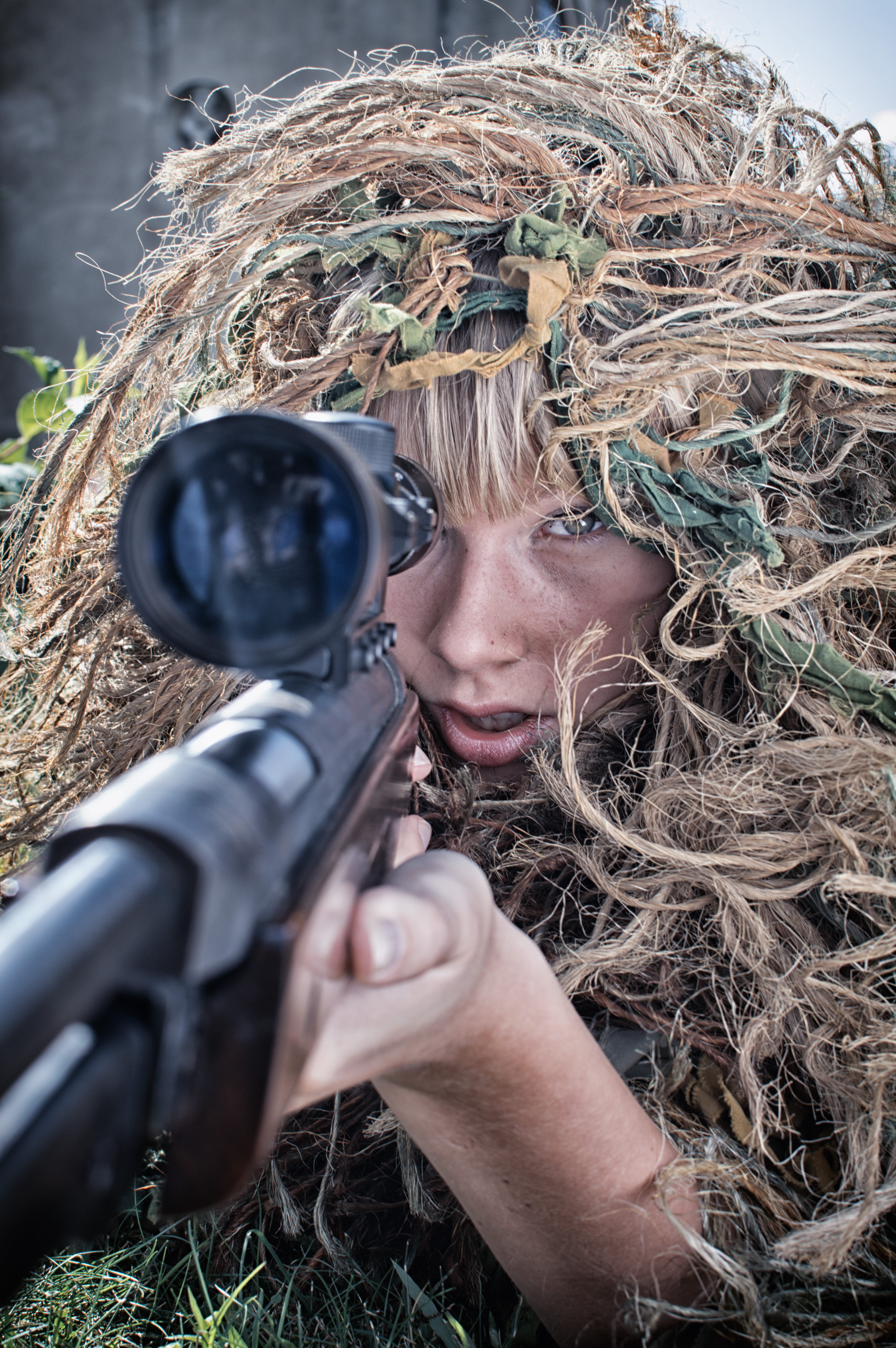 Sniper girl, woman in camouflage pointing sniper, ghillie suit