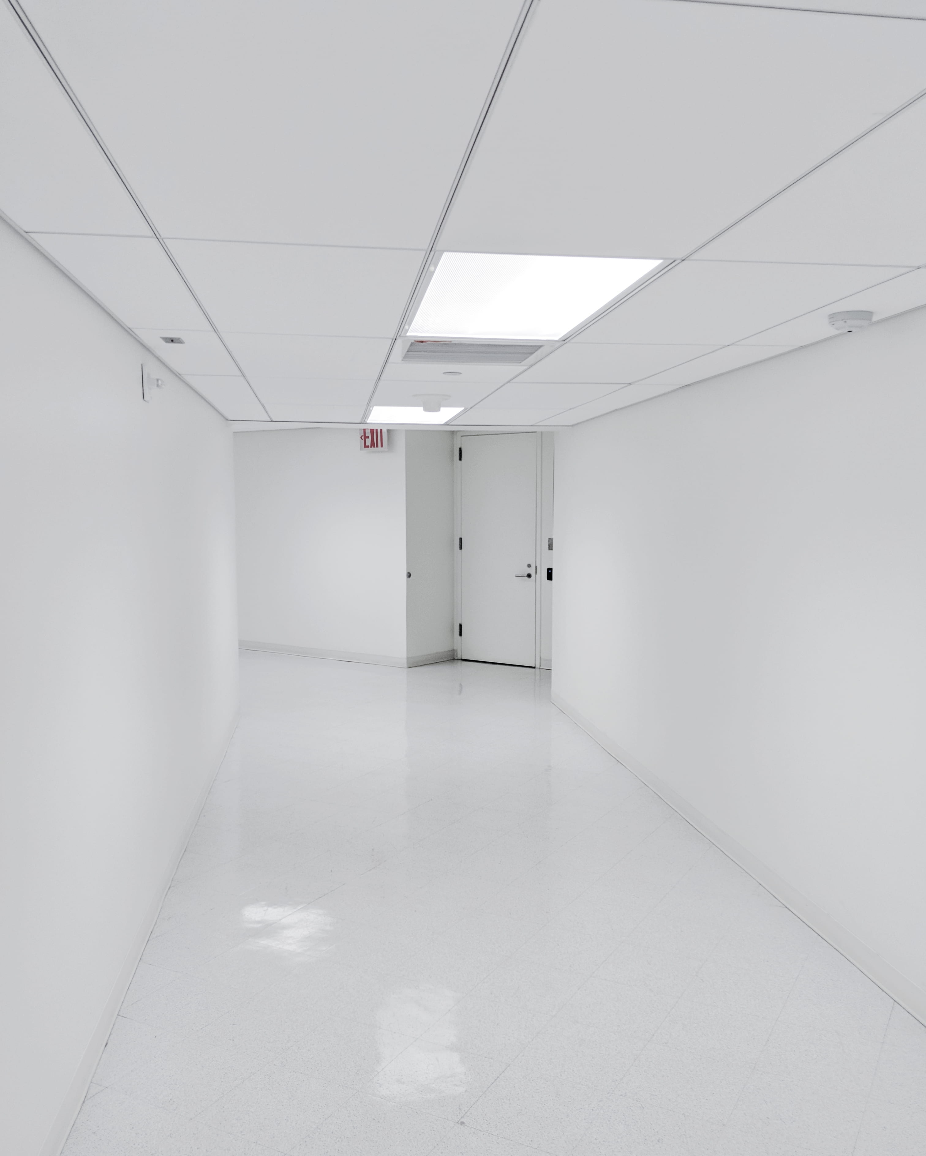 empty hallway, white walkway inside building, corridor, exit