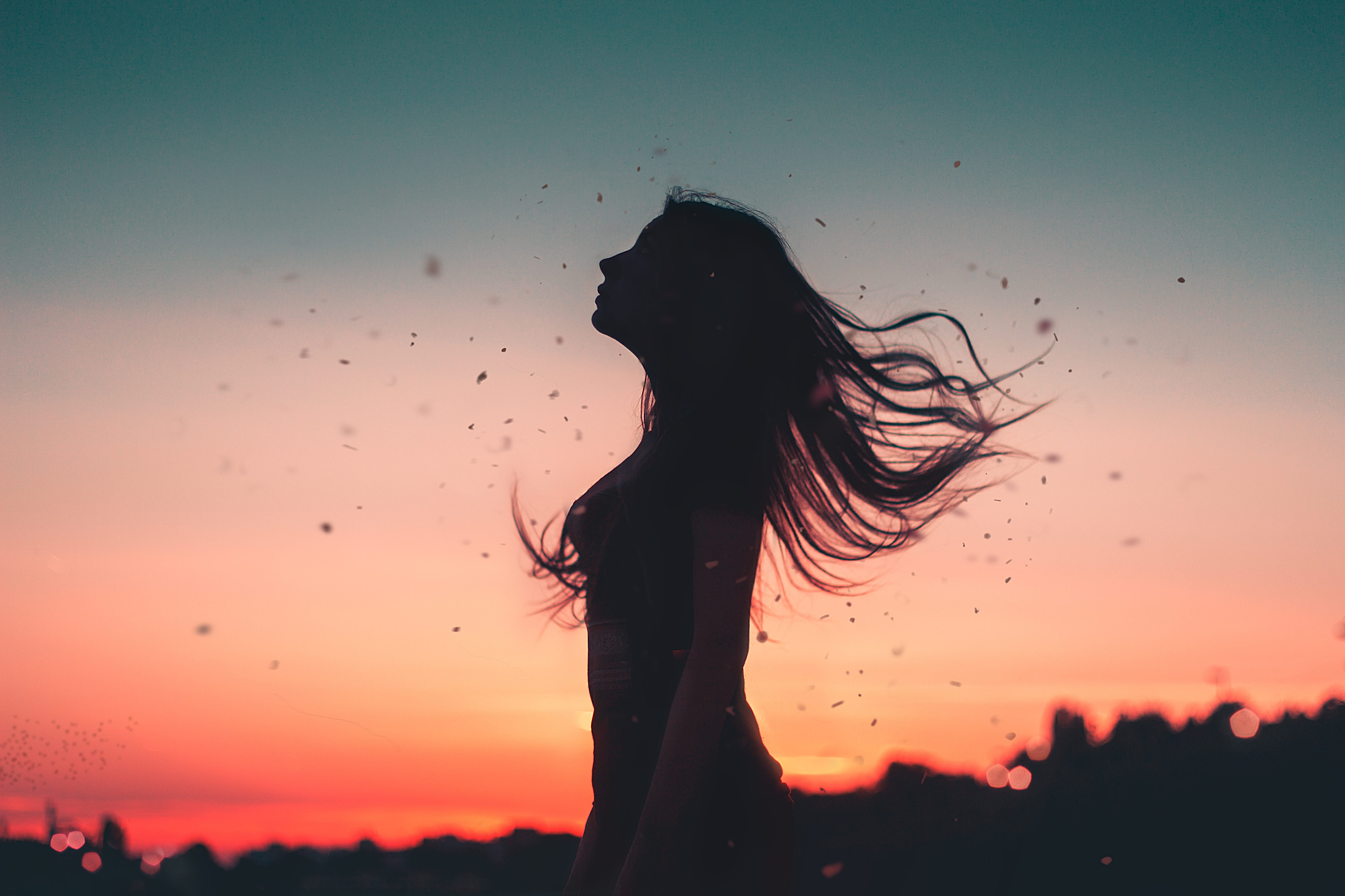woman standing during golden hour, wind, girl, hair, silhouette