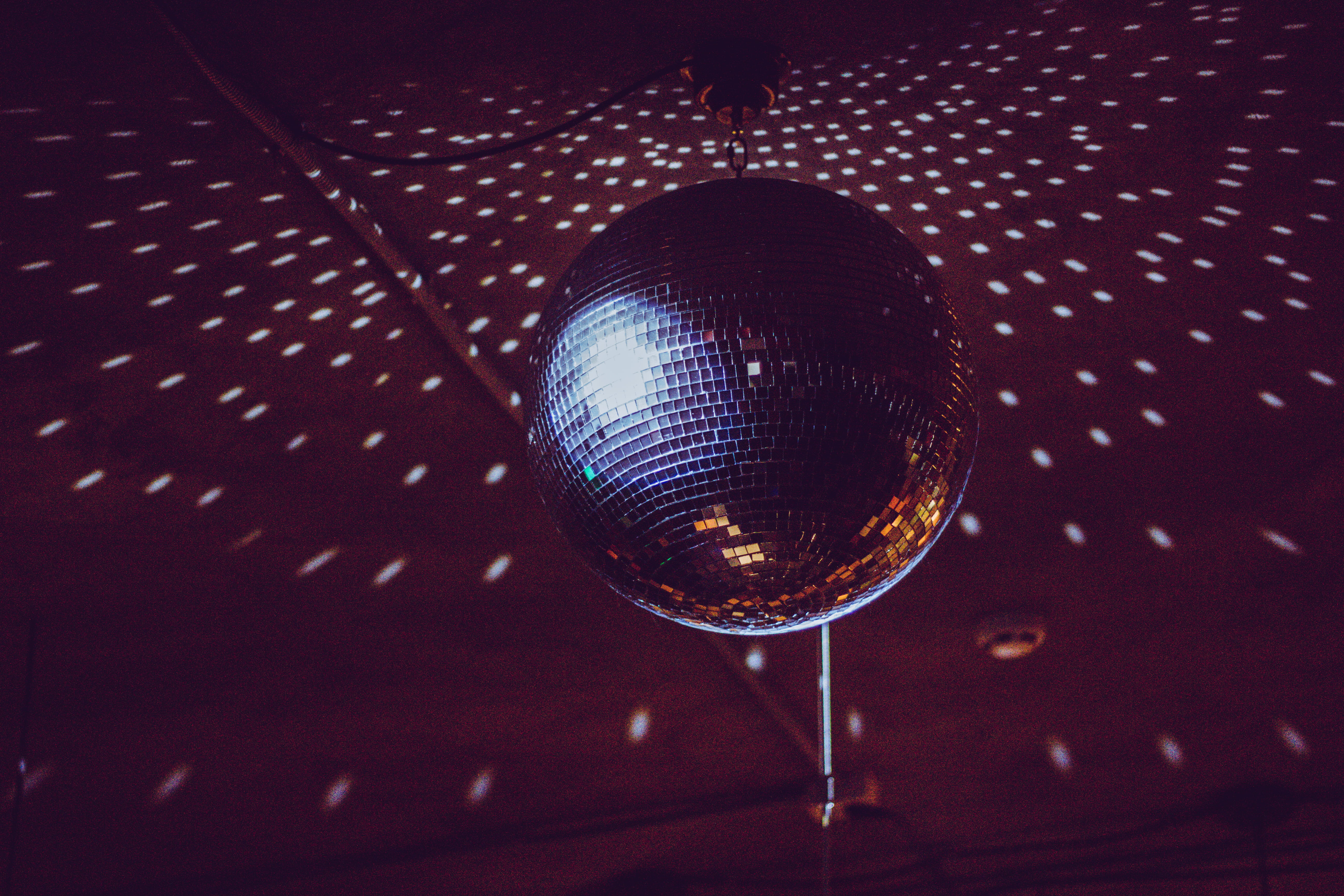 silver disco ball, black and brown disco ball turned on inside room