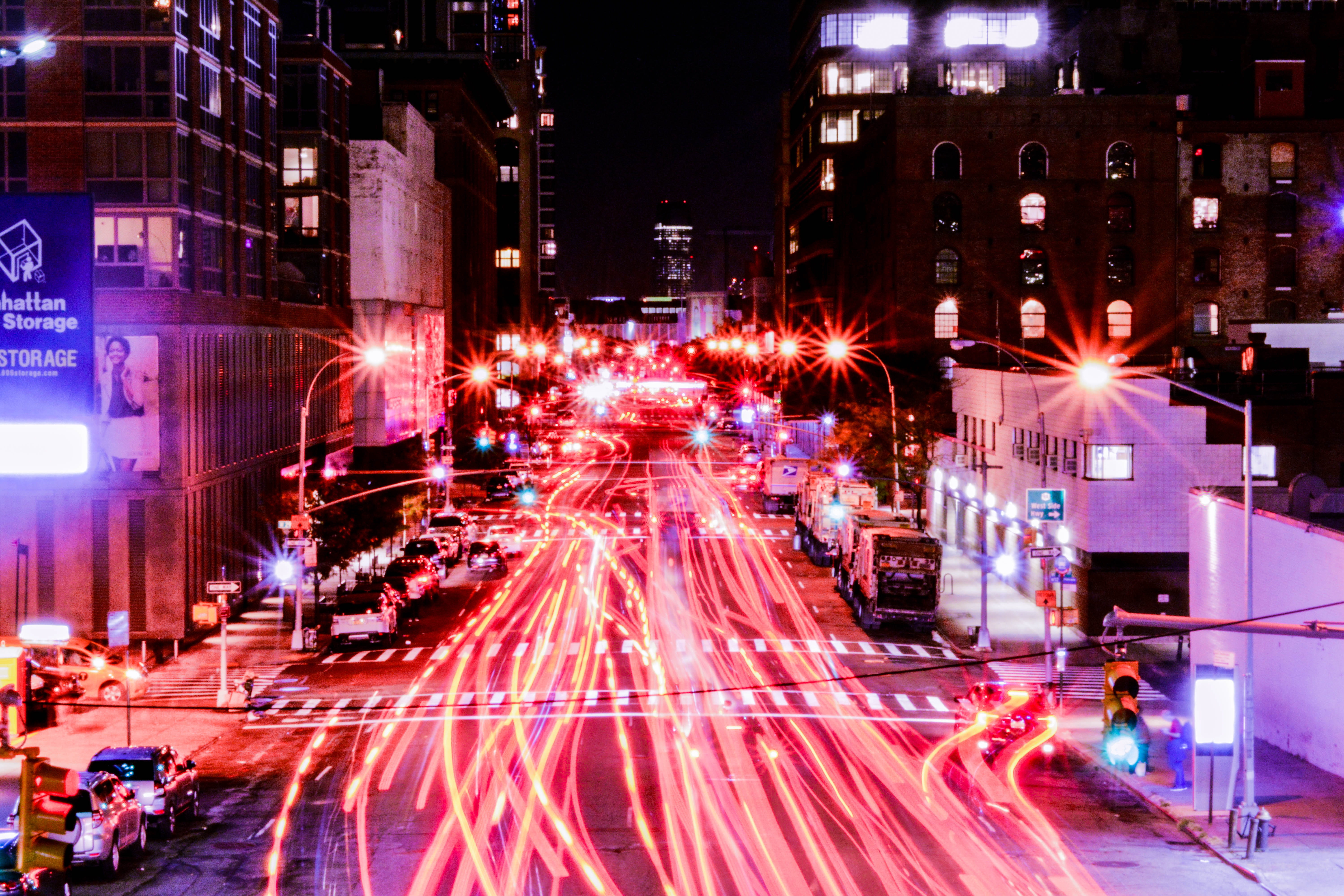 time lapse photography of cars on road between buildings at night time, timelapse photography of cars