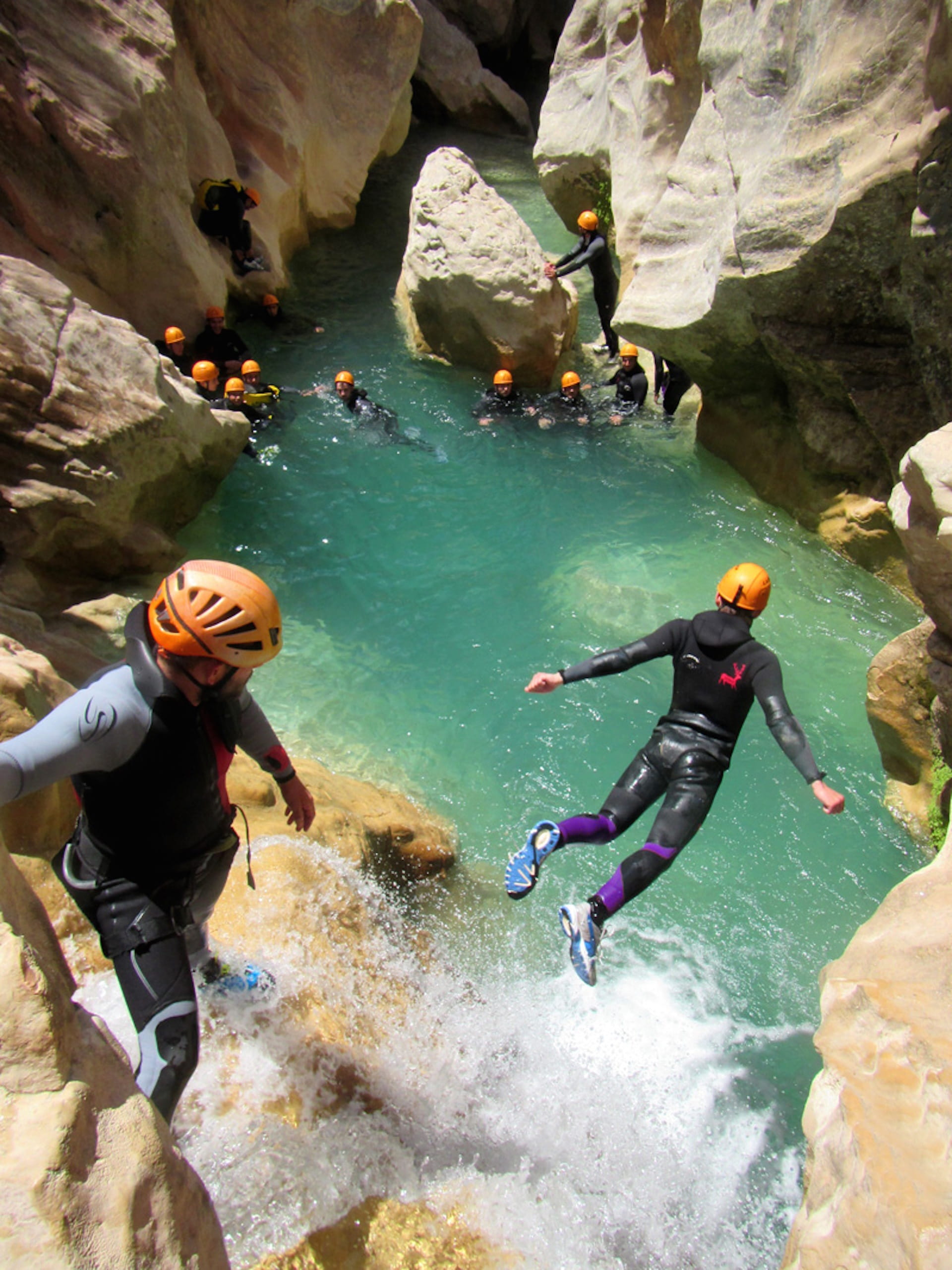 person wearing black and purple wetsuit jumping, Canyoning, Guara