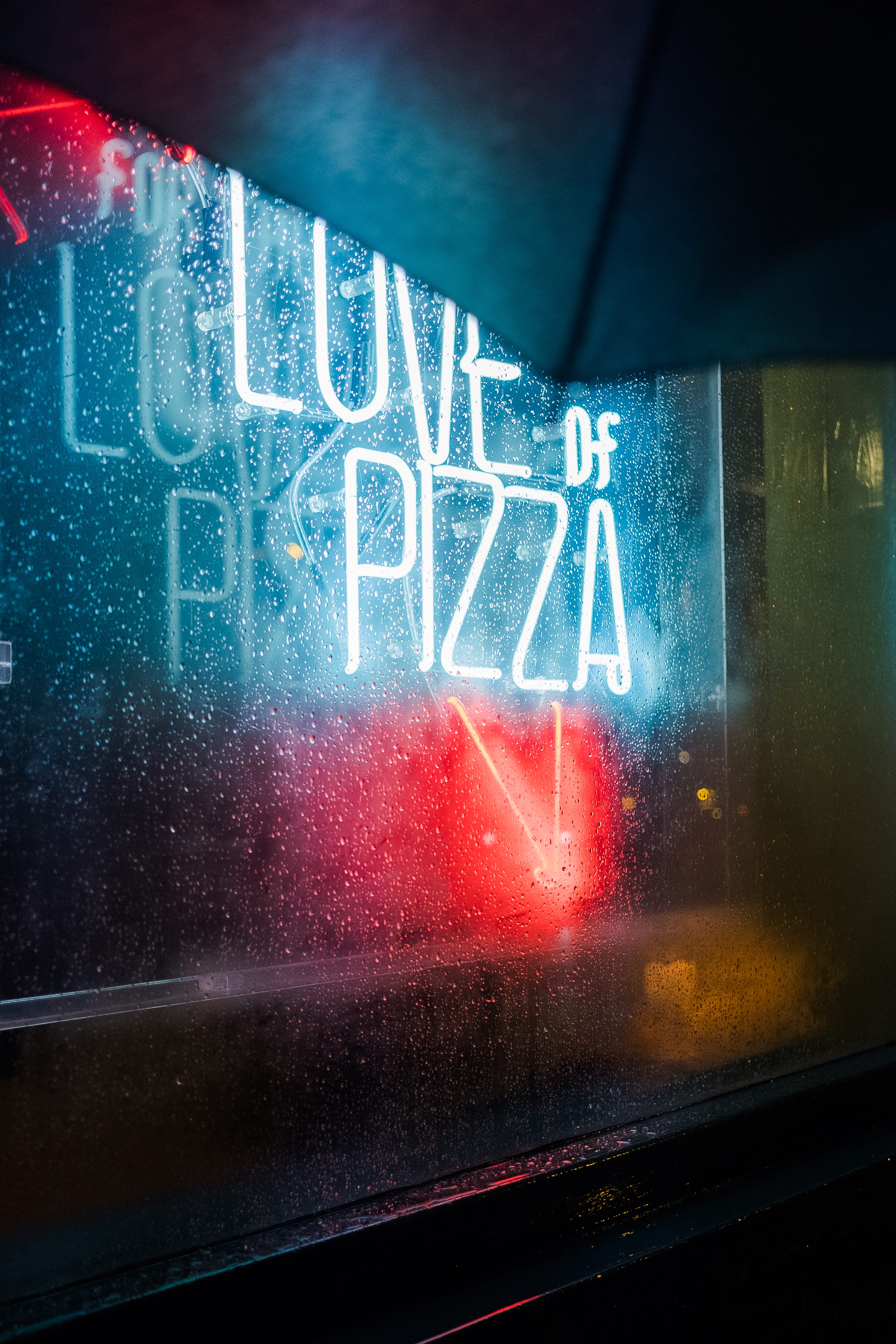 closeup photo of love of pizza neon light signage, love of pizza neon lights signage