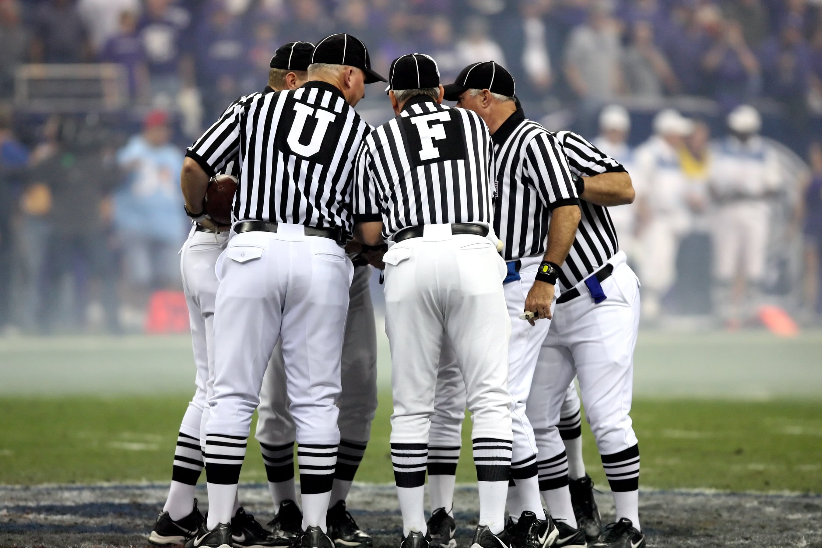 referees forming a circle, american football, american football officials