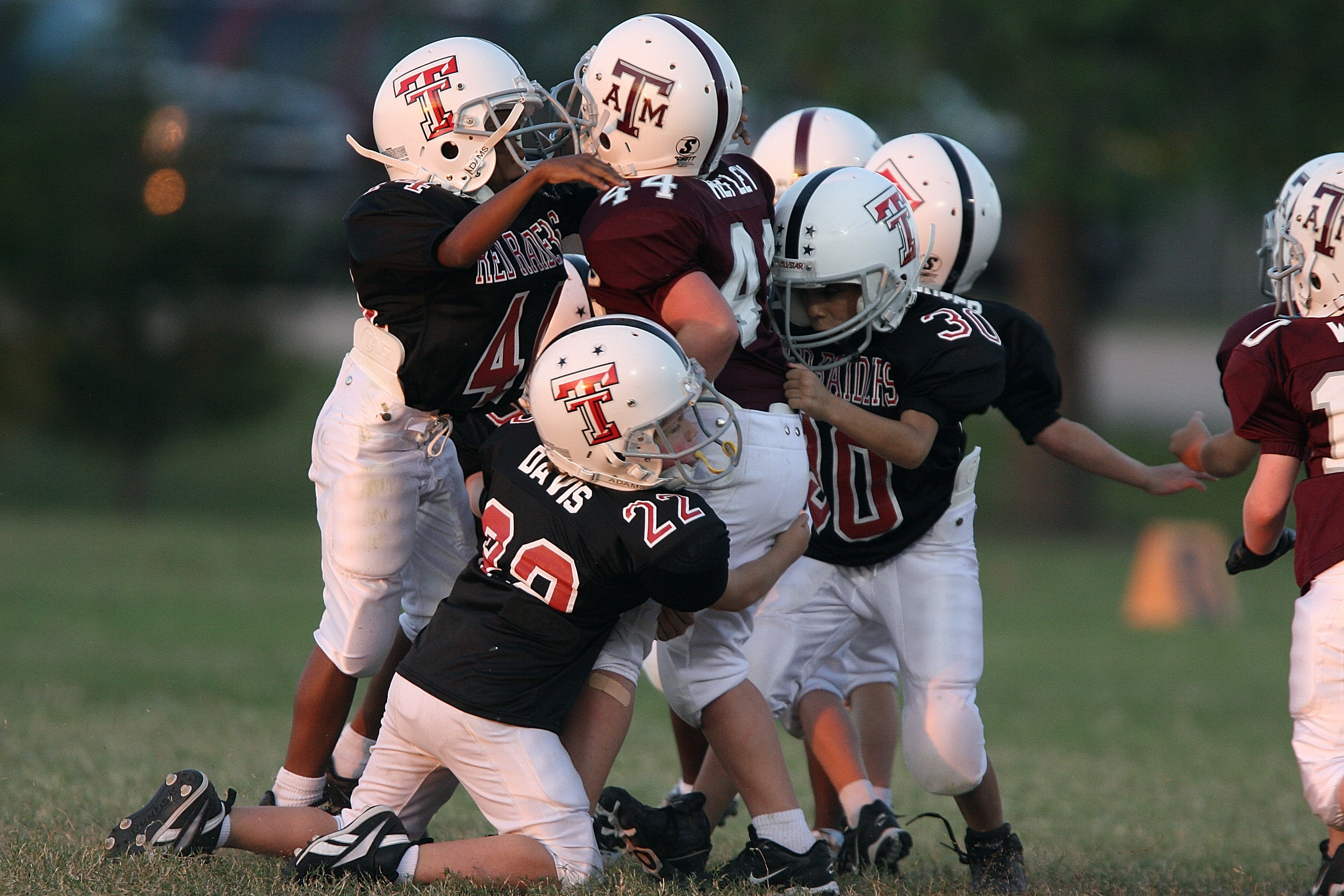 group of children playing football, american, youth league, players