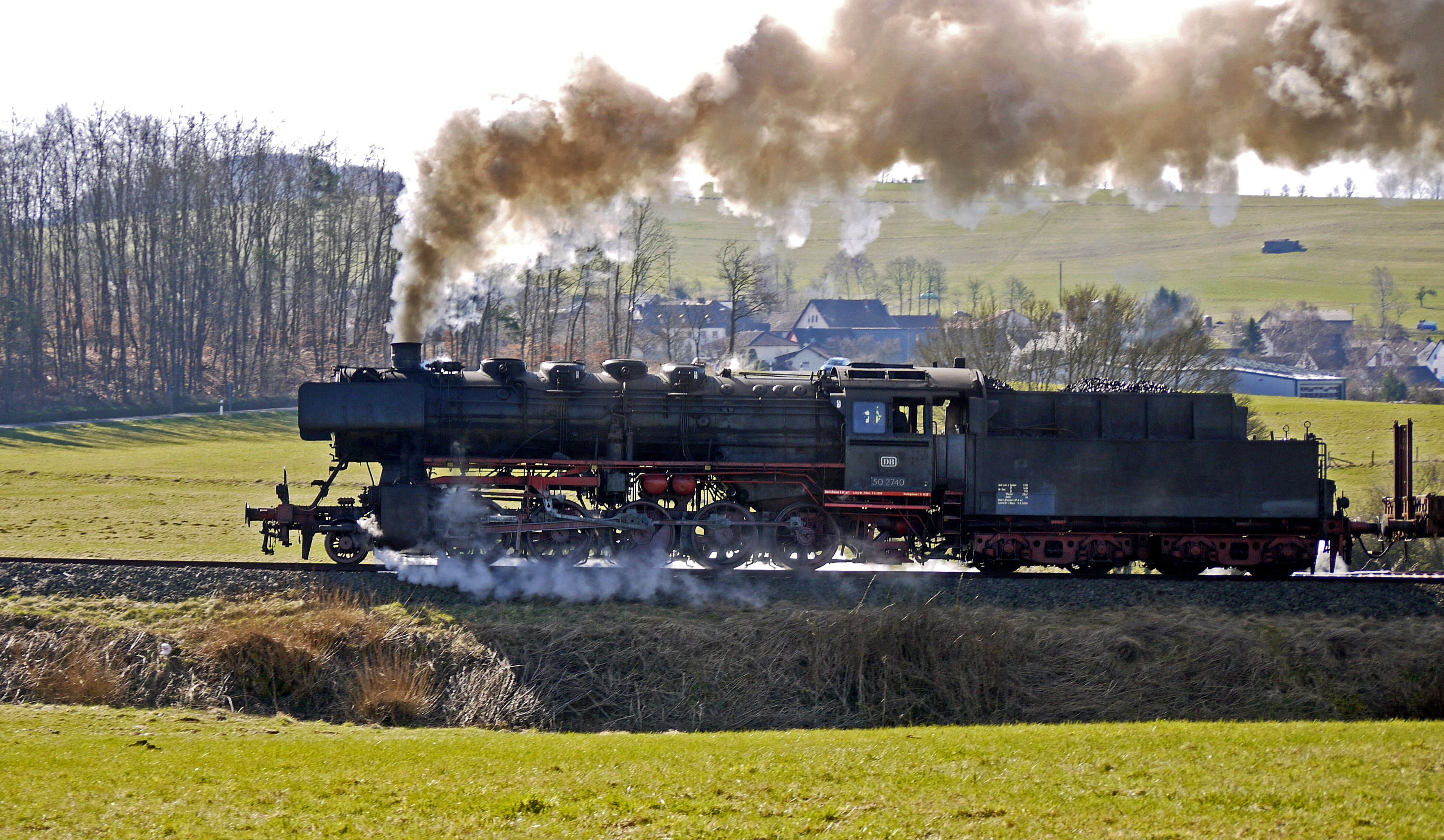 black steel train on black steel rail, steam locomotive, mountain ride