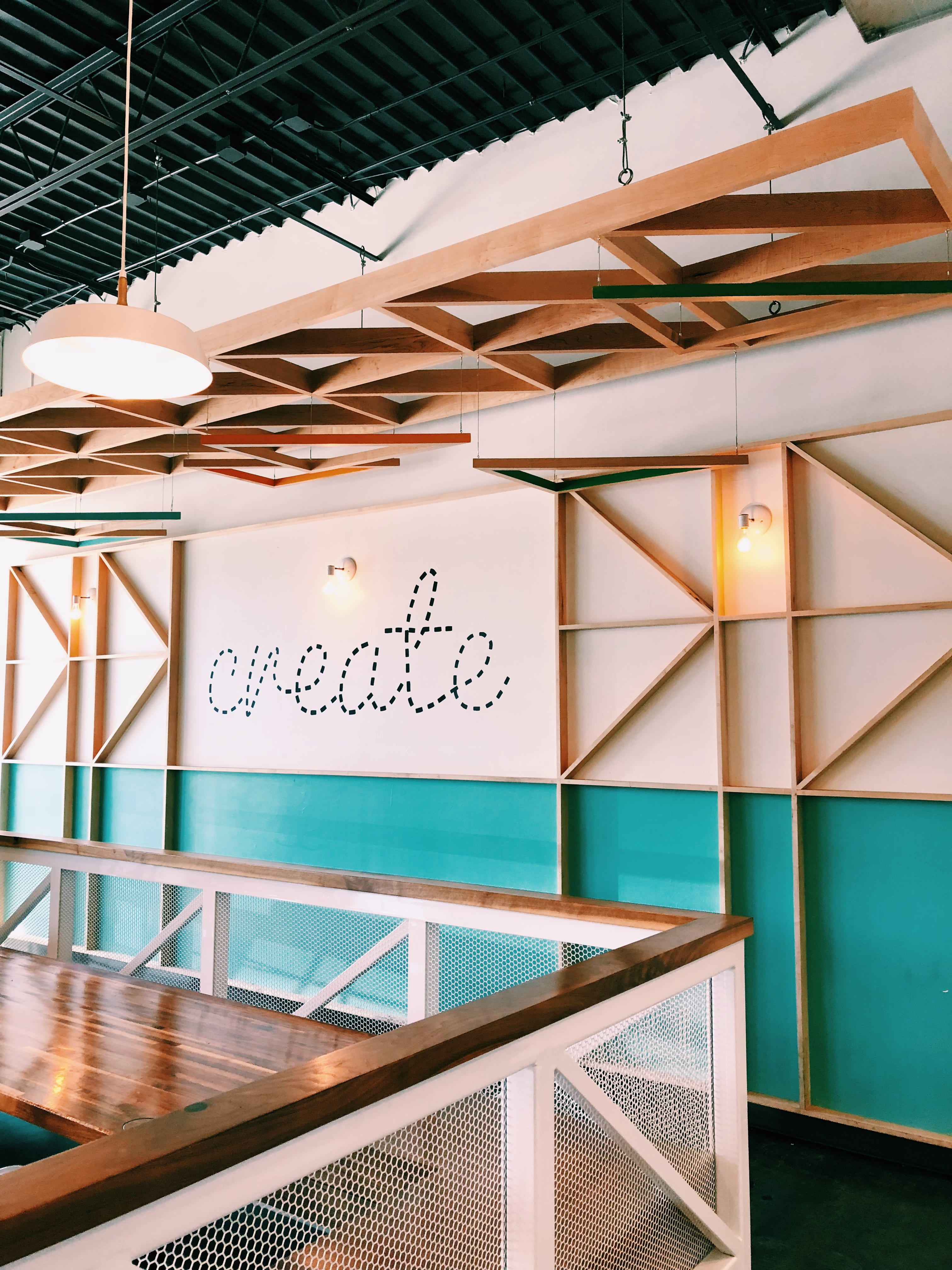 brown wooden wall with create decal, white and teal painted walls